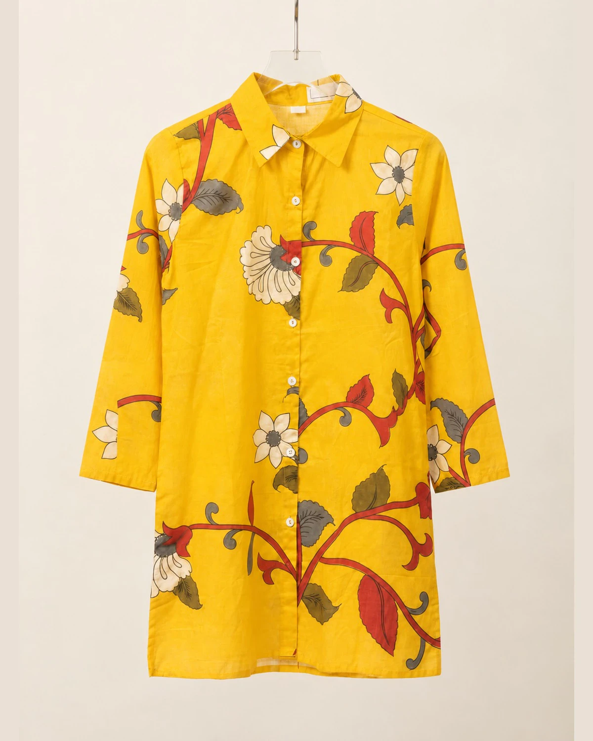 Yellow floral vine print cotton shirt kurti on a hanger, front view