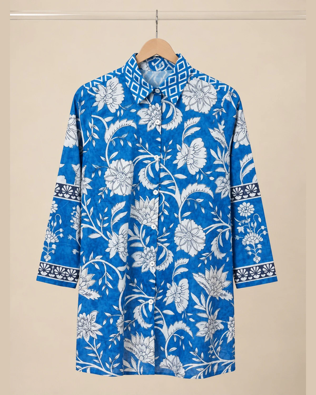 Blue and white floral print cotton shirt kurti on a hanger, front view