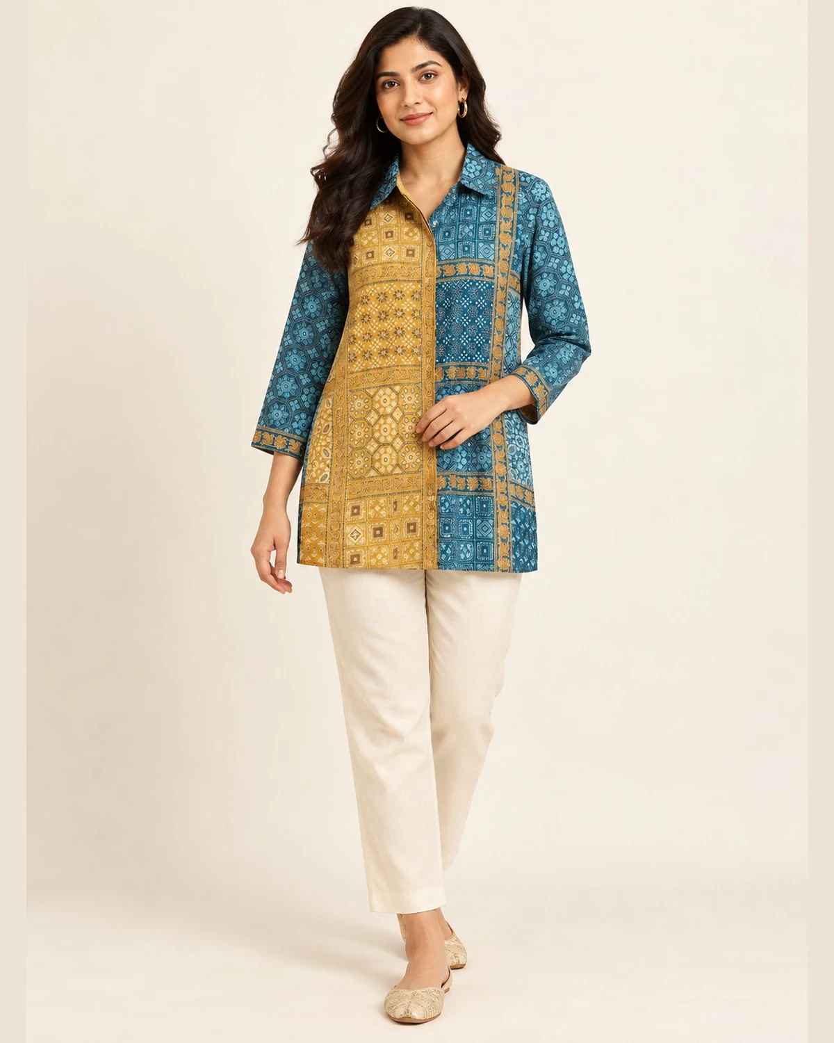Woman wearing a teal and mustard two-tone geometric print shirt kurti with cream trousers