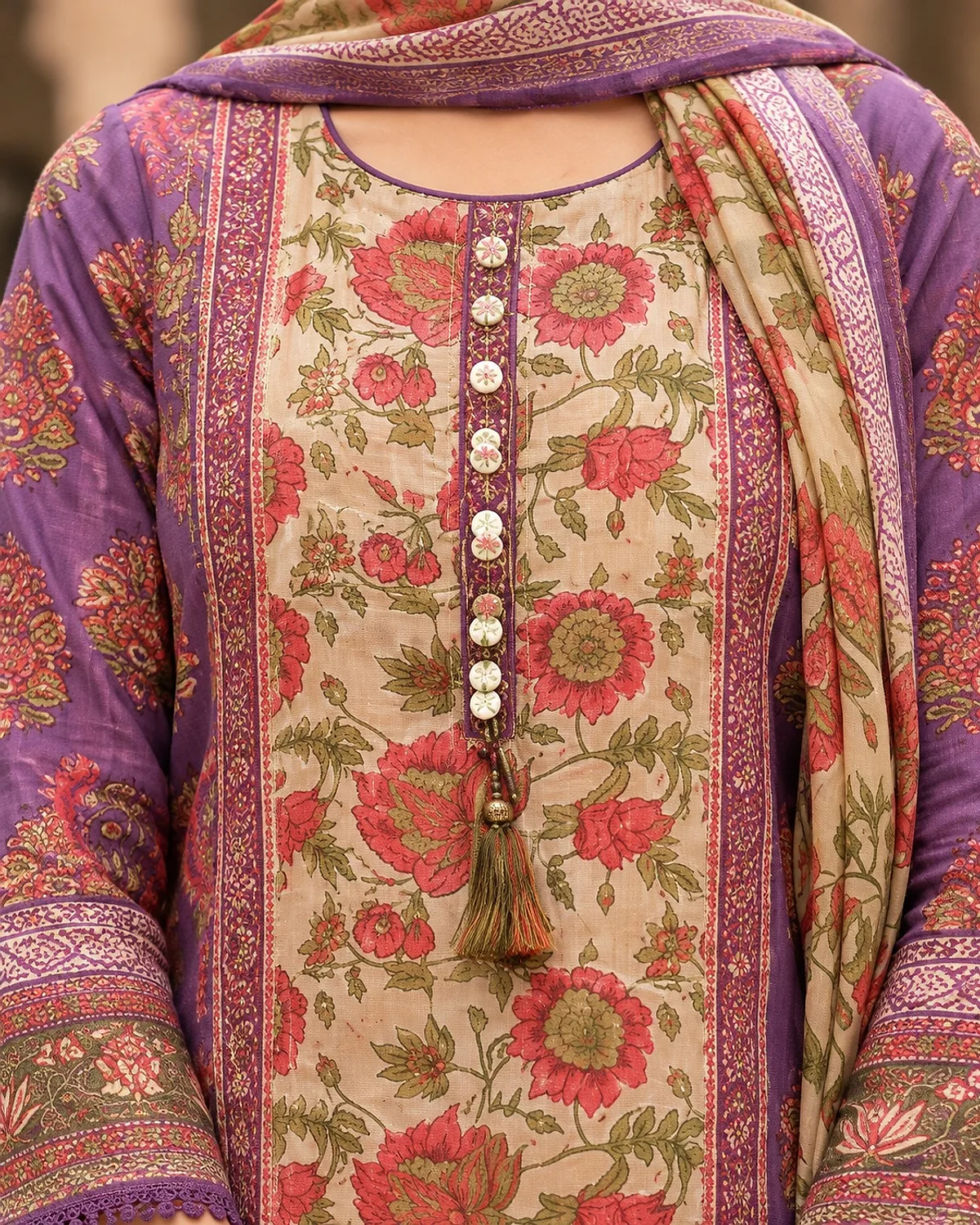 Close-up of the plum and beige kurta, showing a floral print and a buttoned placket