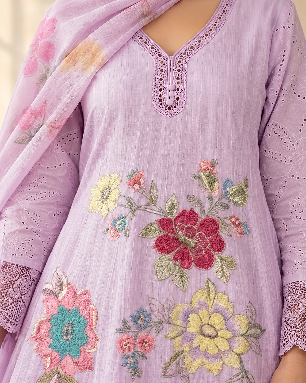 Close-up of the lilac kurta, showing multicolour floral embroidery and cutwork lace