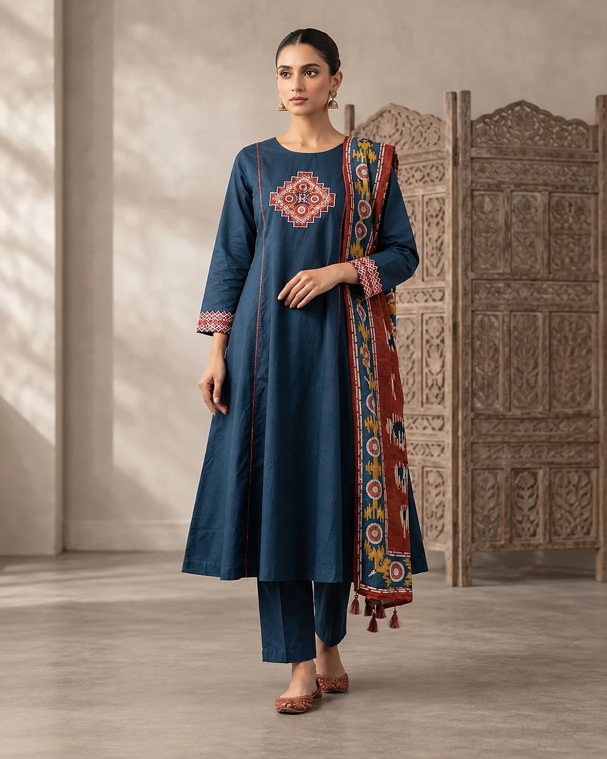 Woman wearing a navy kurta, trousers and dupatta