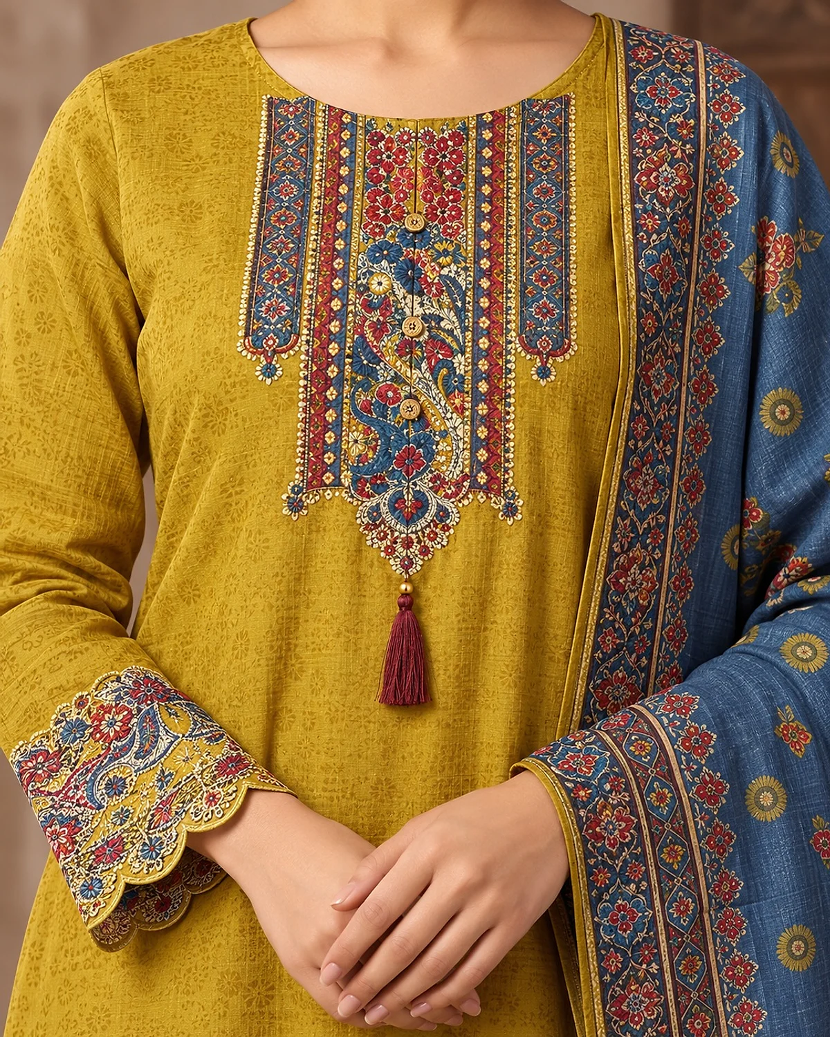 Close-up of the mustard kurta, showing a printed yoke and scalloped hem