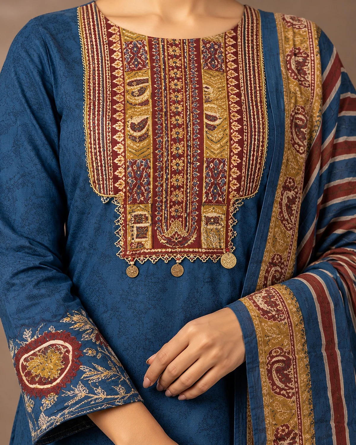 Close-up of the blue kurta, showing a patterned yoke and scalloped printed hem