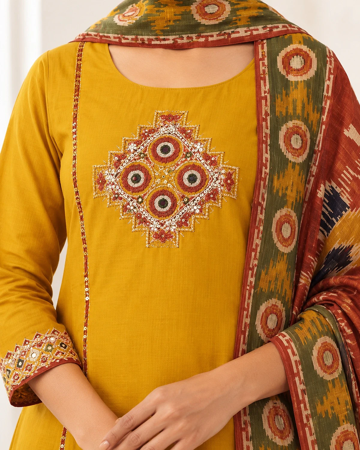 Close-up of the mustard kurta, showing a geometric chest motif