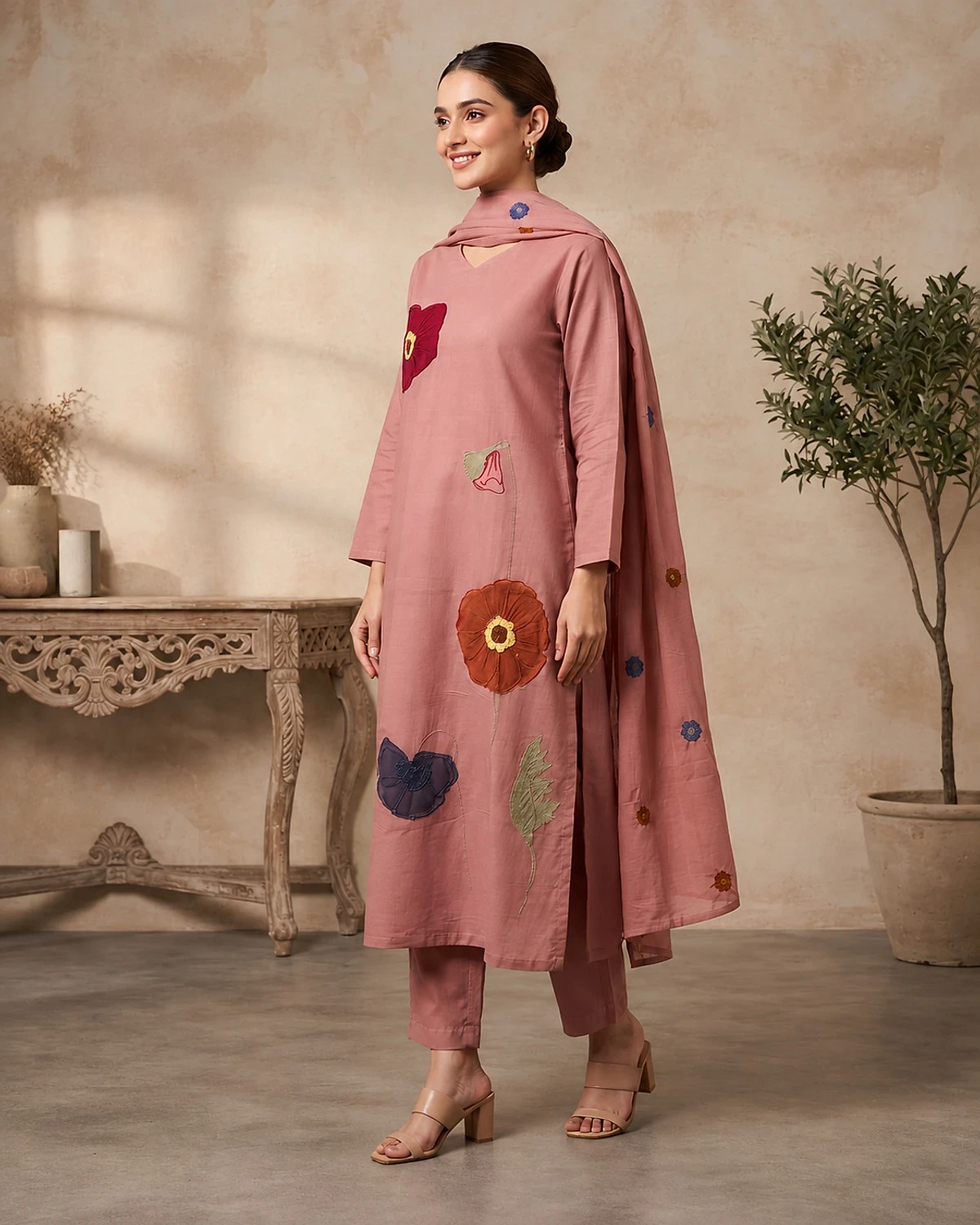 Woman wearing a dusty rose kurta, trousers and dupatta