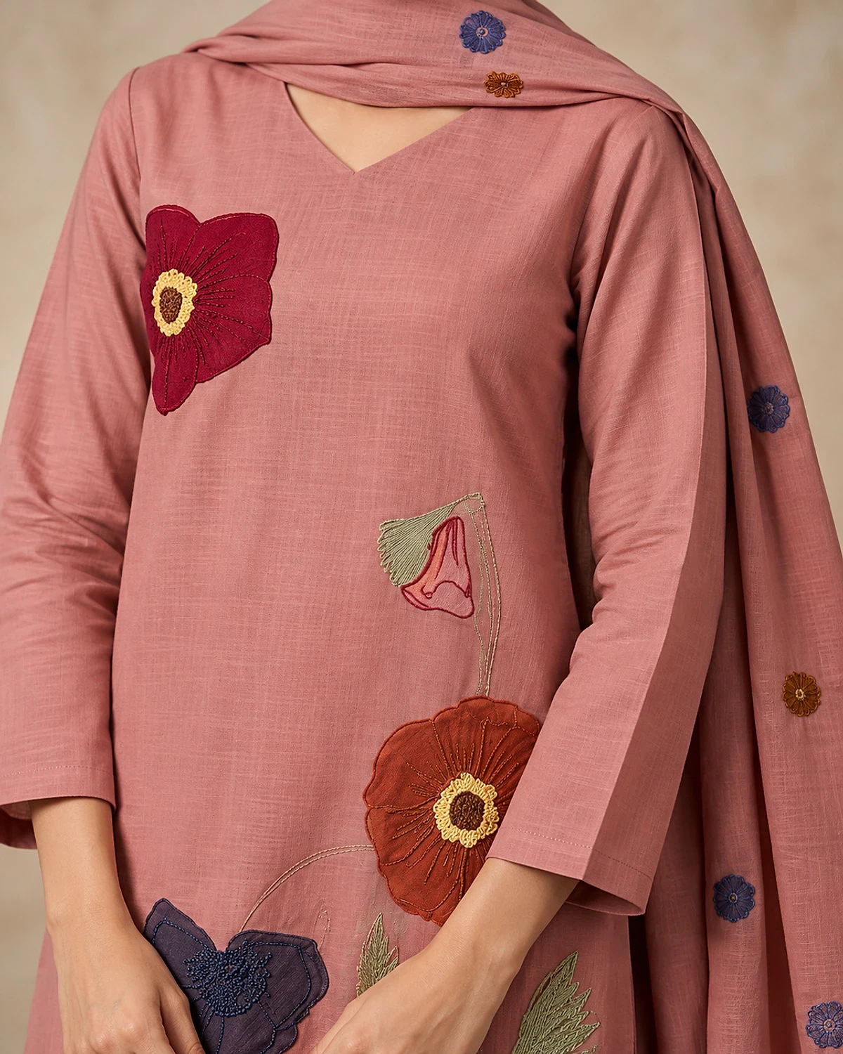 Close-up of the dusty rose kurta, showing large scattered flower motifs