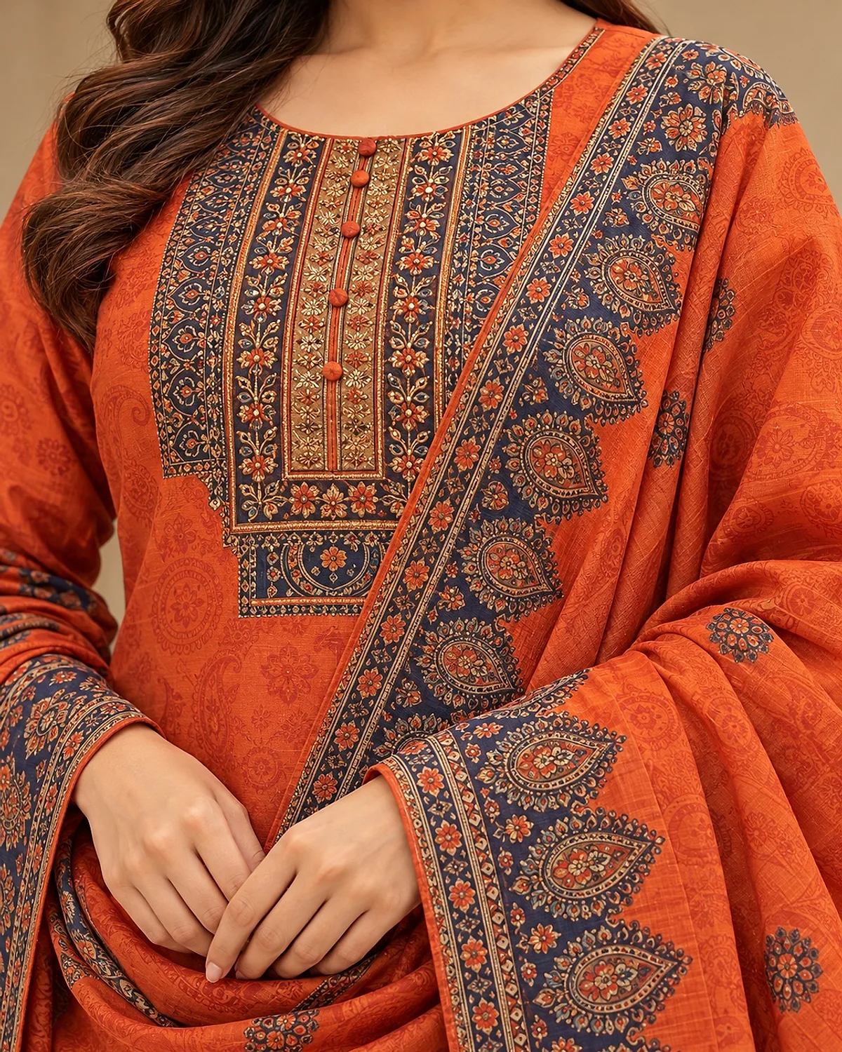 Close-up of the rust orange kurta, showing a navy printed yoke and borders