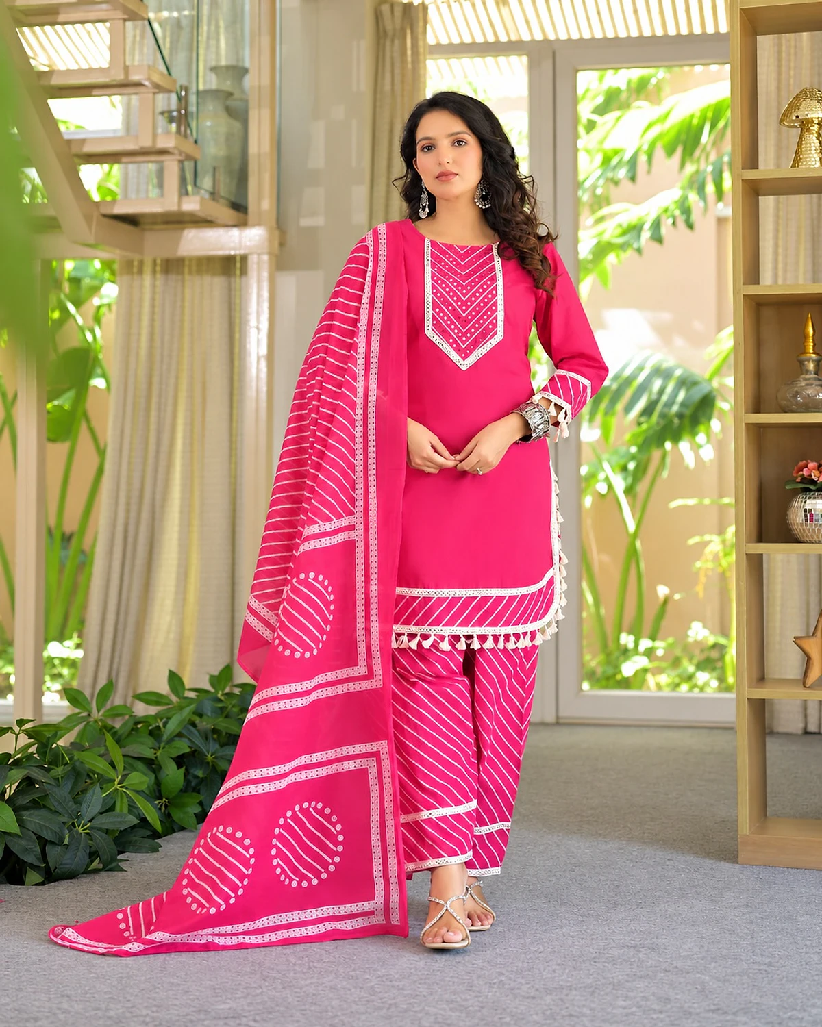 Woman wearing a pink kurta, trousers and dupatta