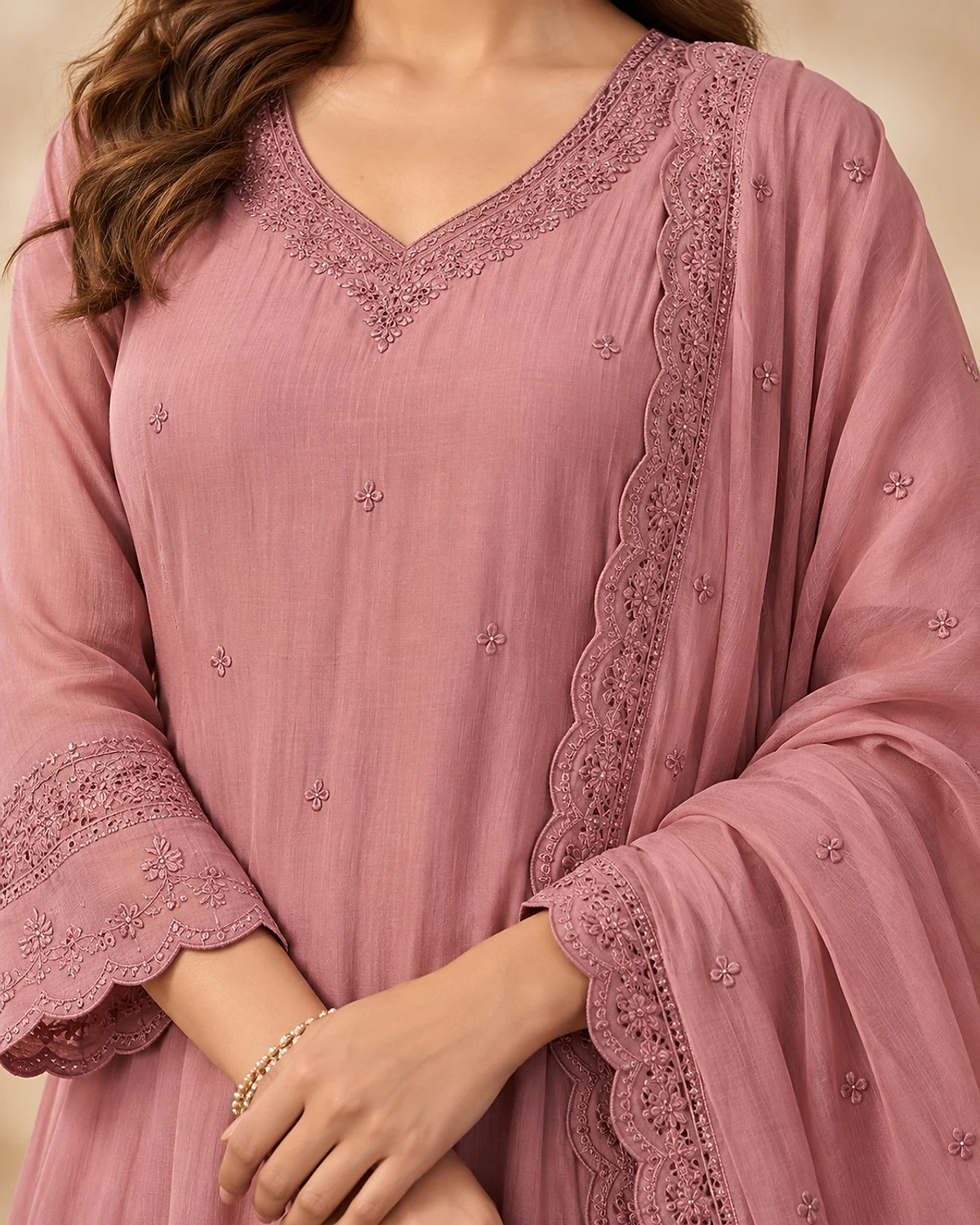 Close-up of the dusty pink kurta, showing tonal cutwork and a scalloped hem