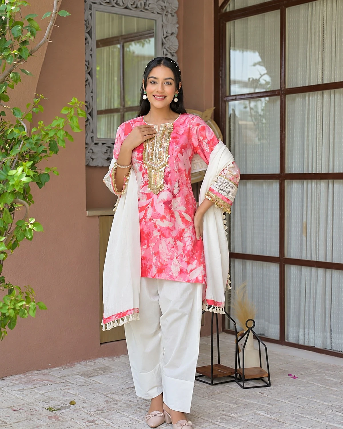 Woman wearing a pink and white kurta, salwar and dupatta