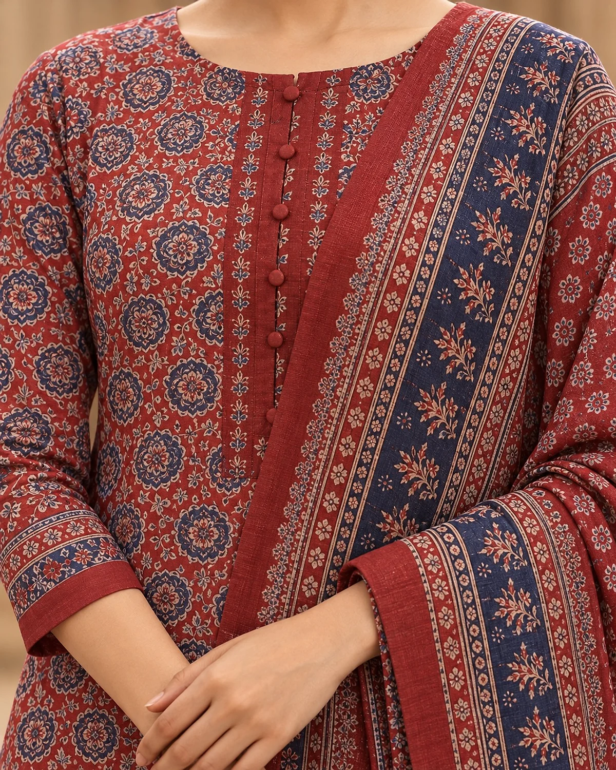 Close-up of the brick red kurta, showing an all-over medallion print