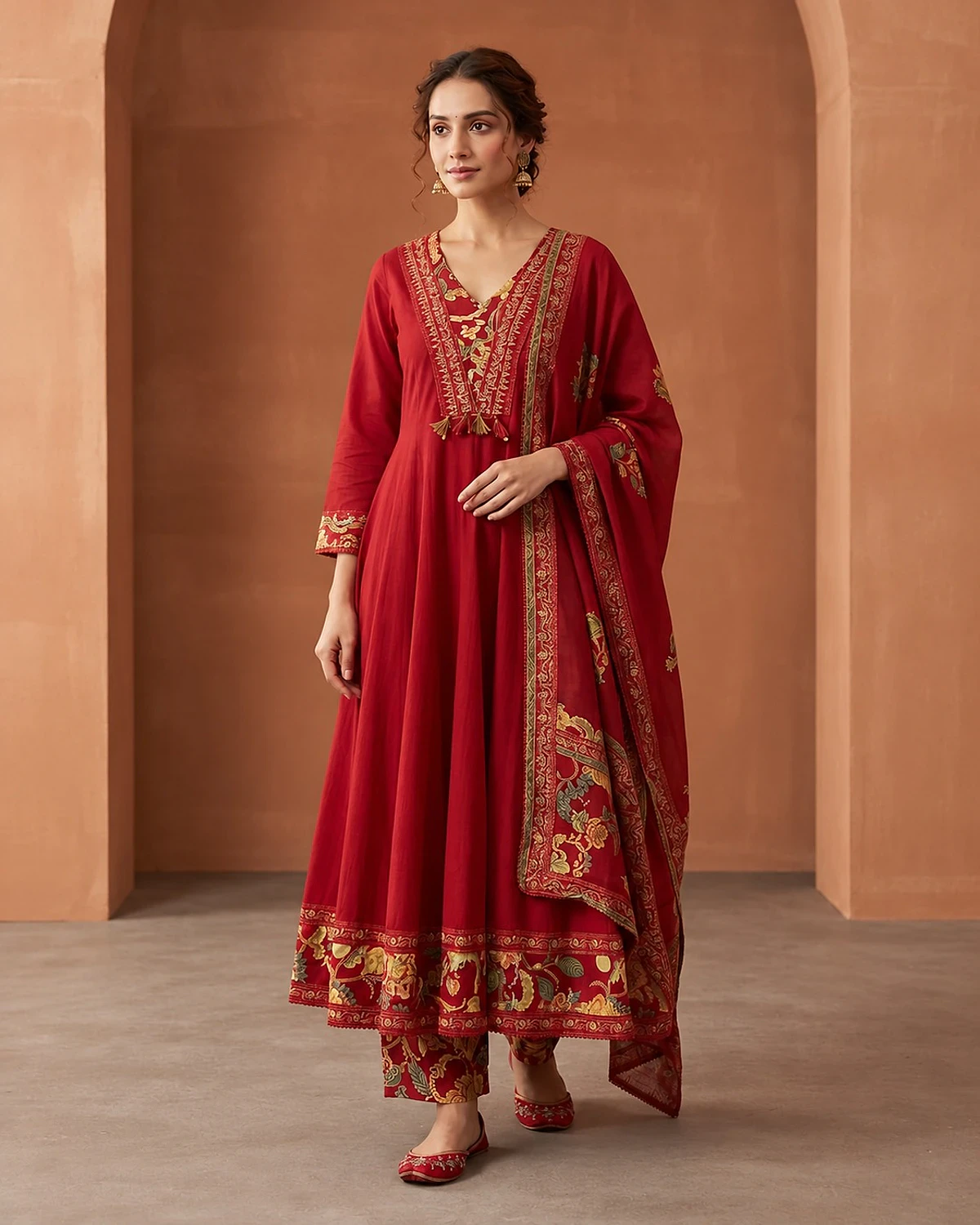 Woman wearing a red kurta, trousers and dupatta