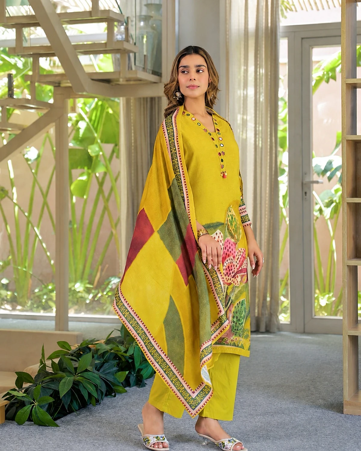 Woman wearing a lime yellow kurta, trousers and dupatta