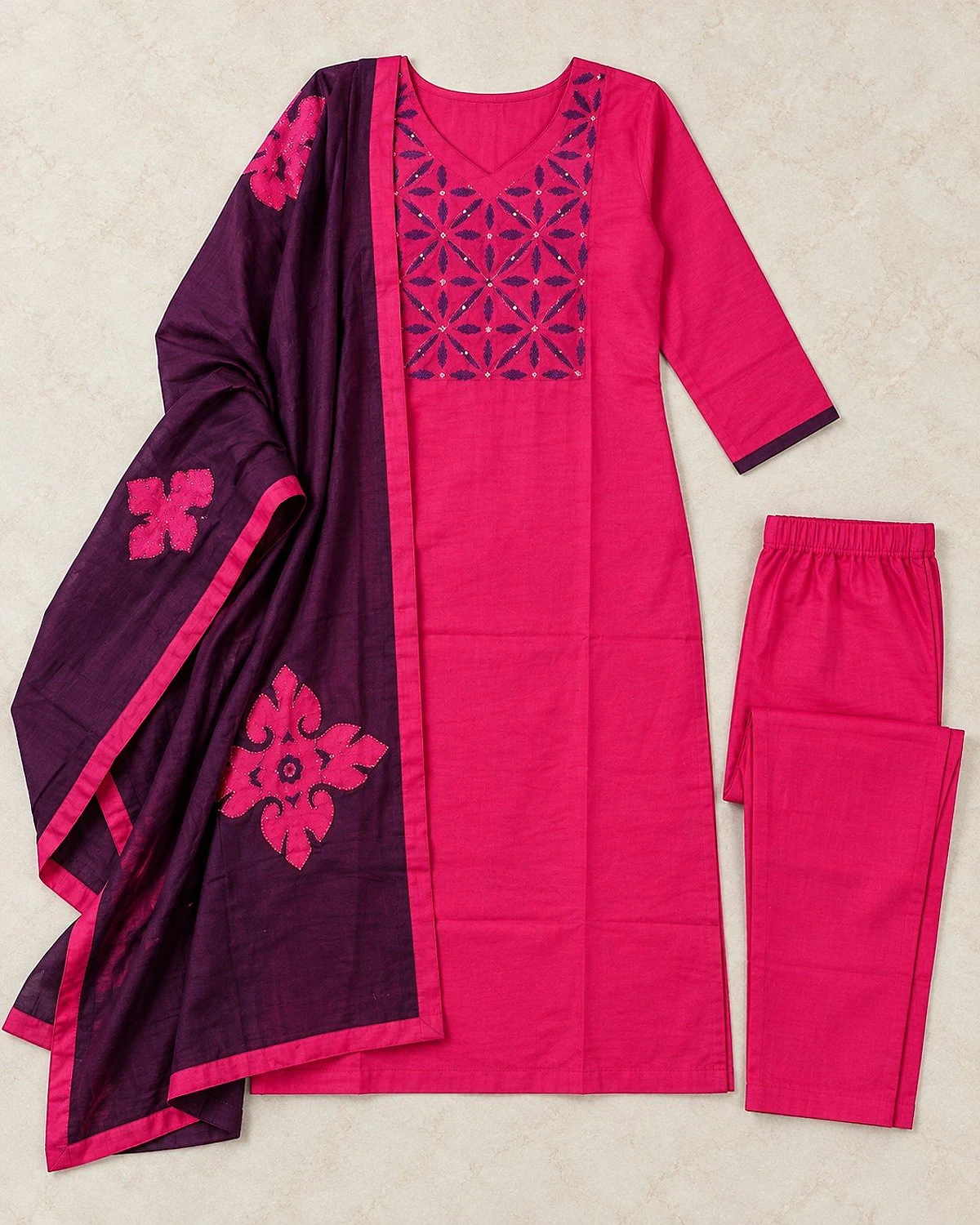 Fuchsia kurta, trousers and dupatta laid out flat
