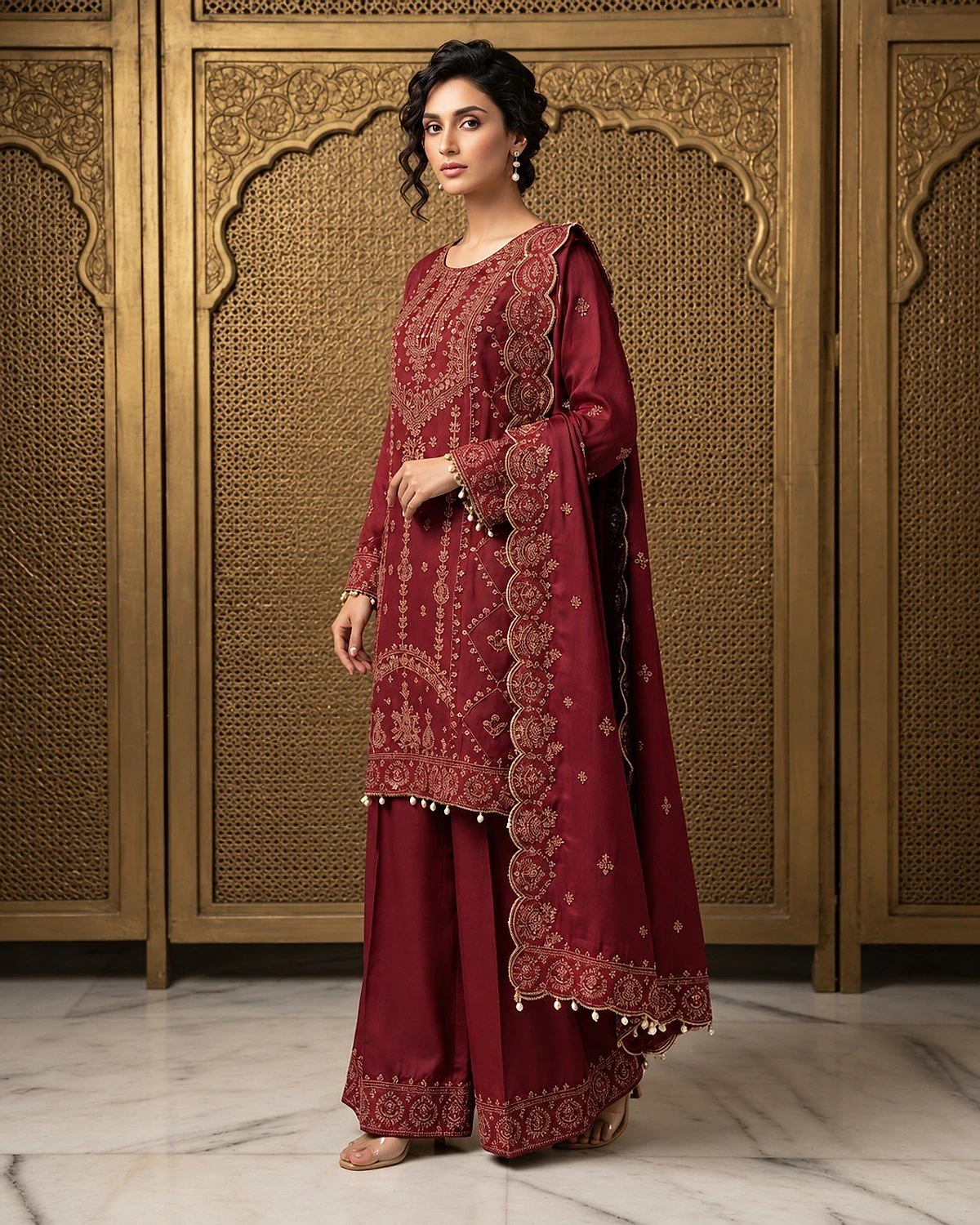 Woman wearing a wine kurta, palazzo and dupatta