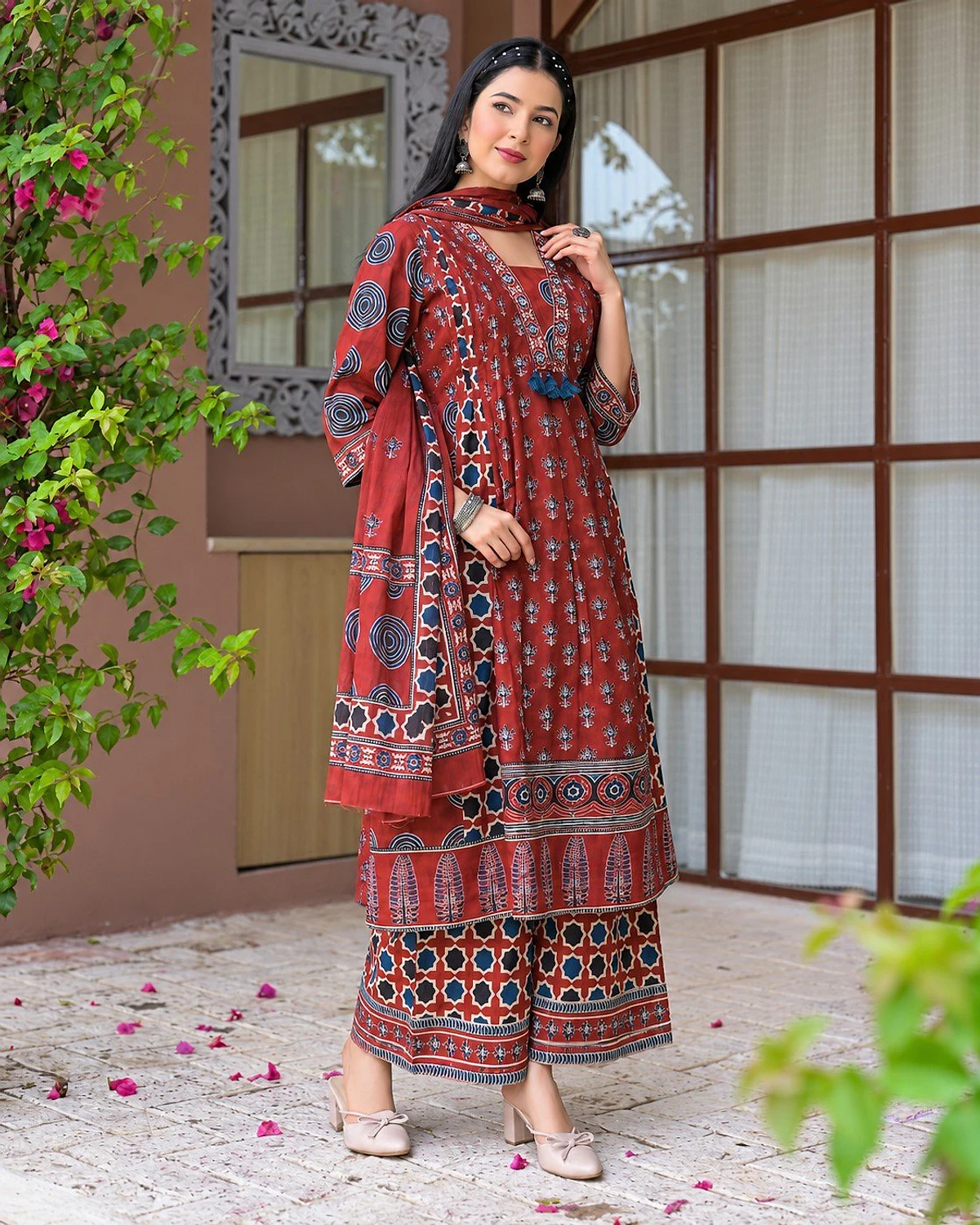 Woman wearing a madder red kurta, palazzo and dupatta