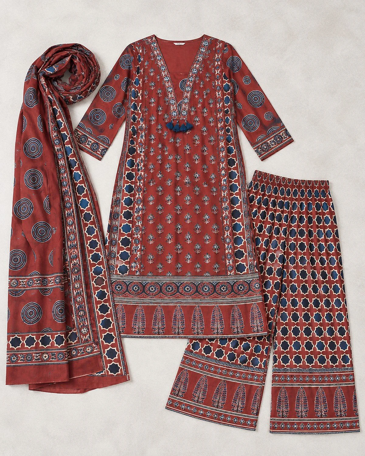 Madder red kurta, palazzo and dupatta laid out flat