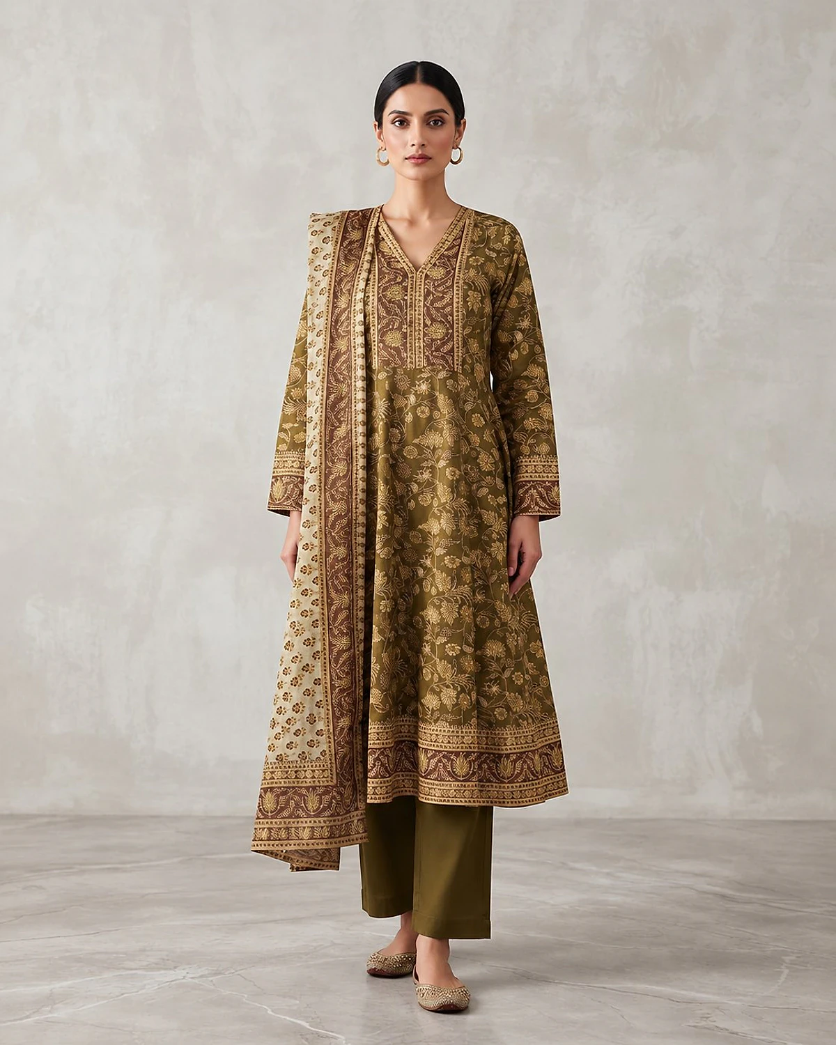 Woman wearing an olive green kurta, trousers and dupatta