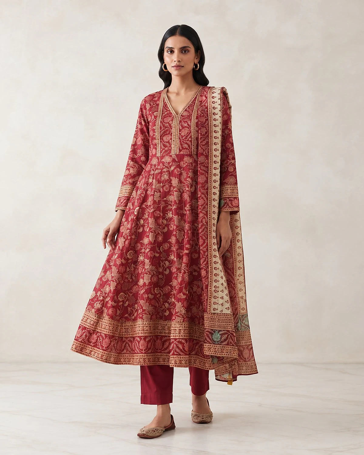 Woman wearing a crimson kurta, trousers and dupatta