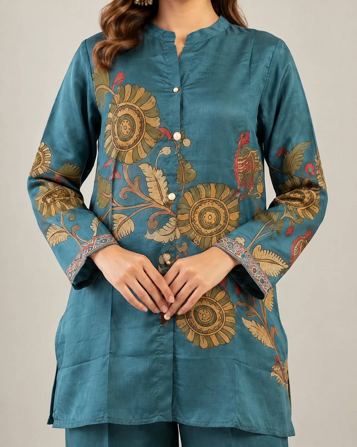 Close-up of the blue tunic's floral print and button front