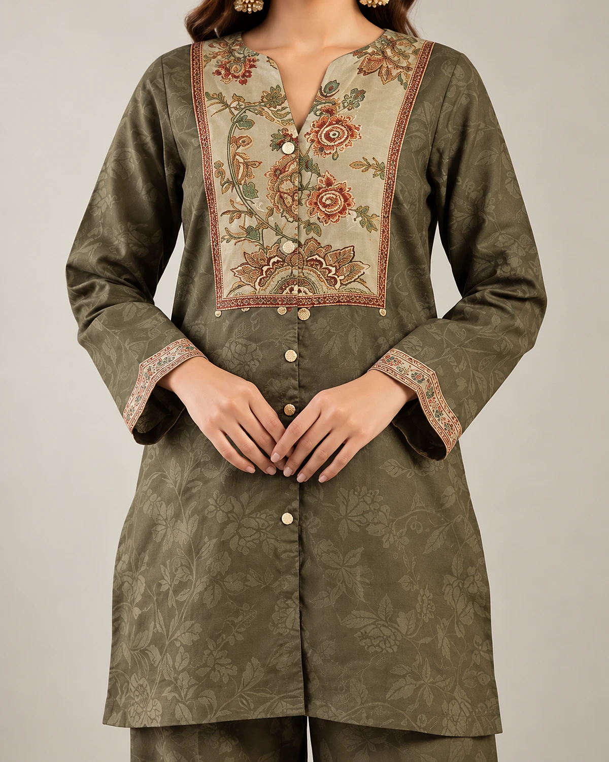 Close-up of the printed floral yoke on the mehendi green tunic