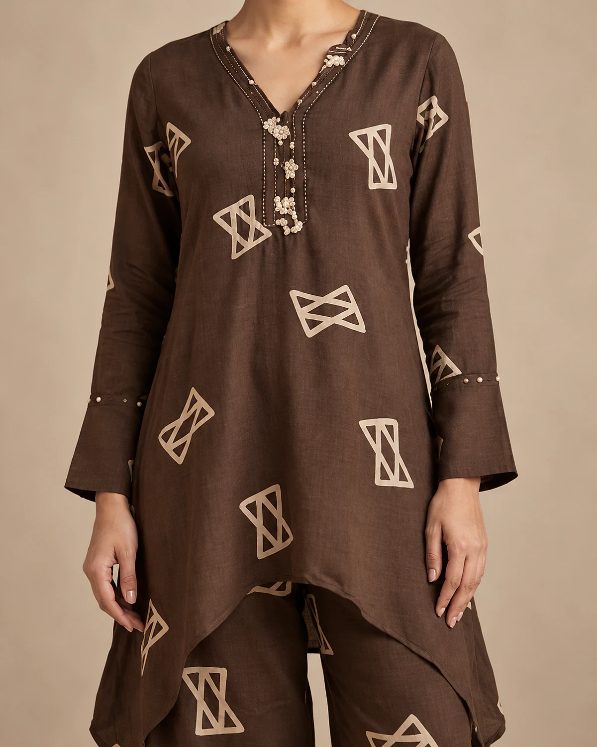 Close-up of the brown kurta's geometric print and beaded placket