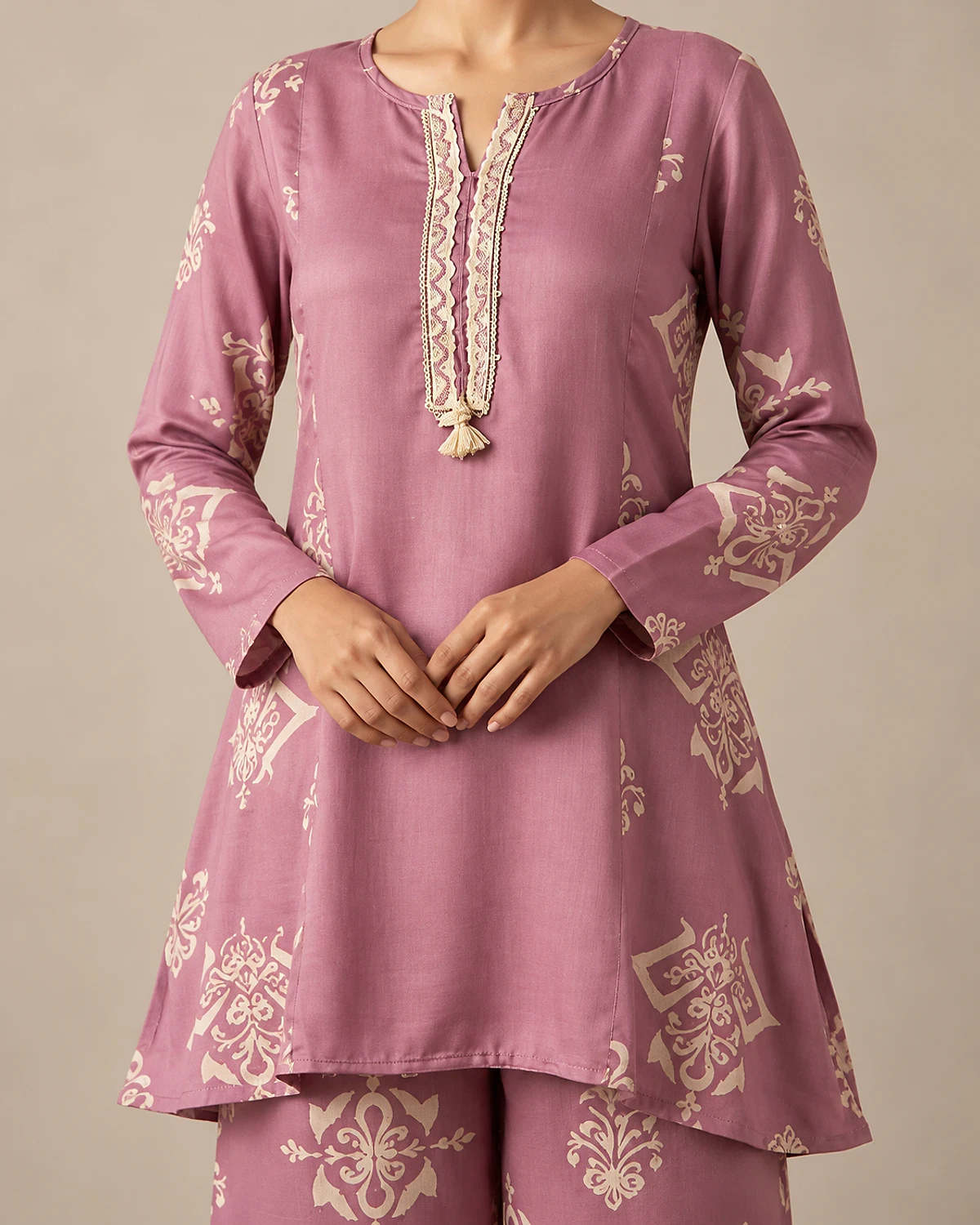 Close-up of the lavender kurta's lace placket and tassel tie