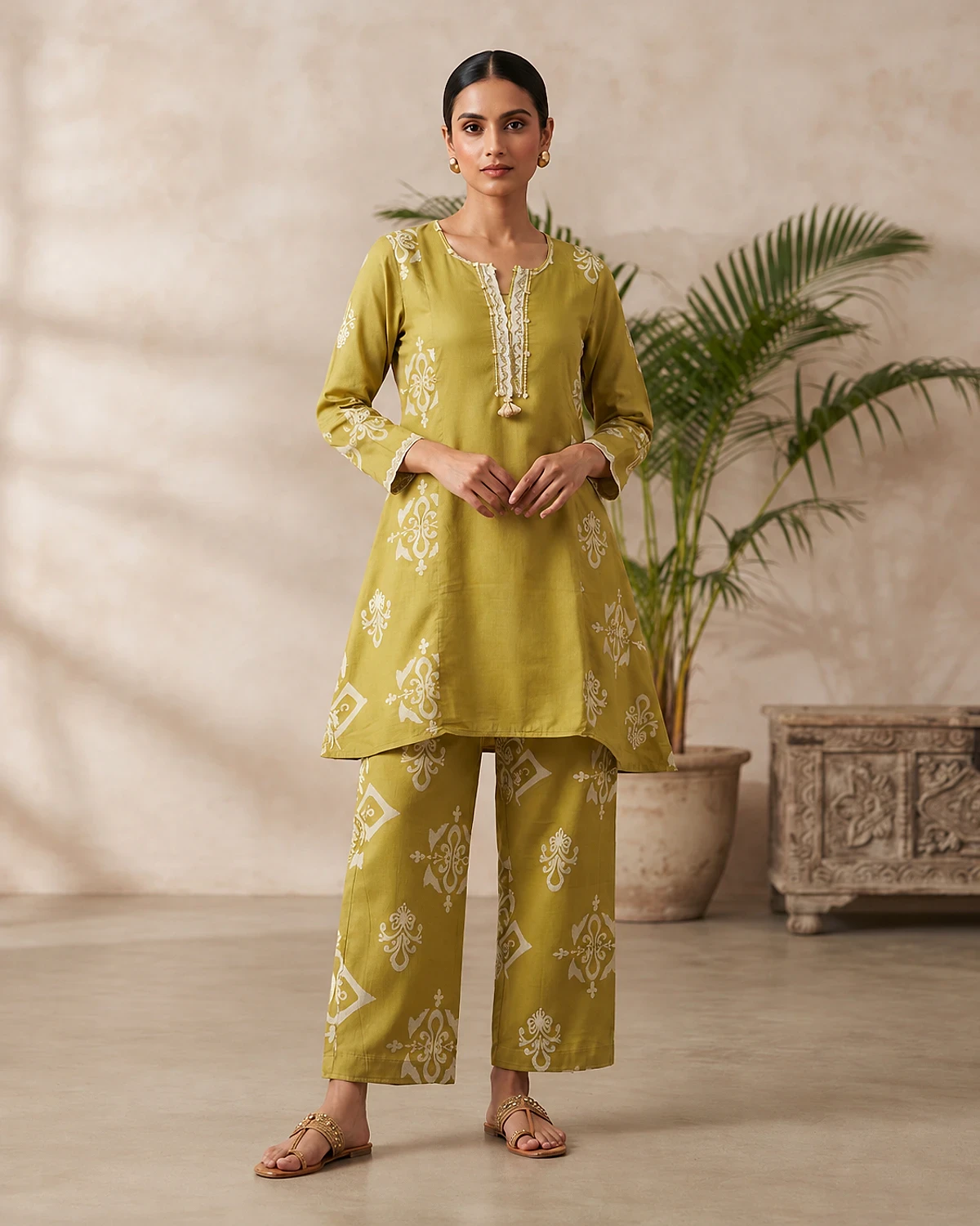 Woman wearing a mehendi green motif print rayon kurta and trousers