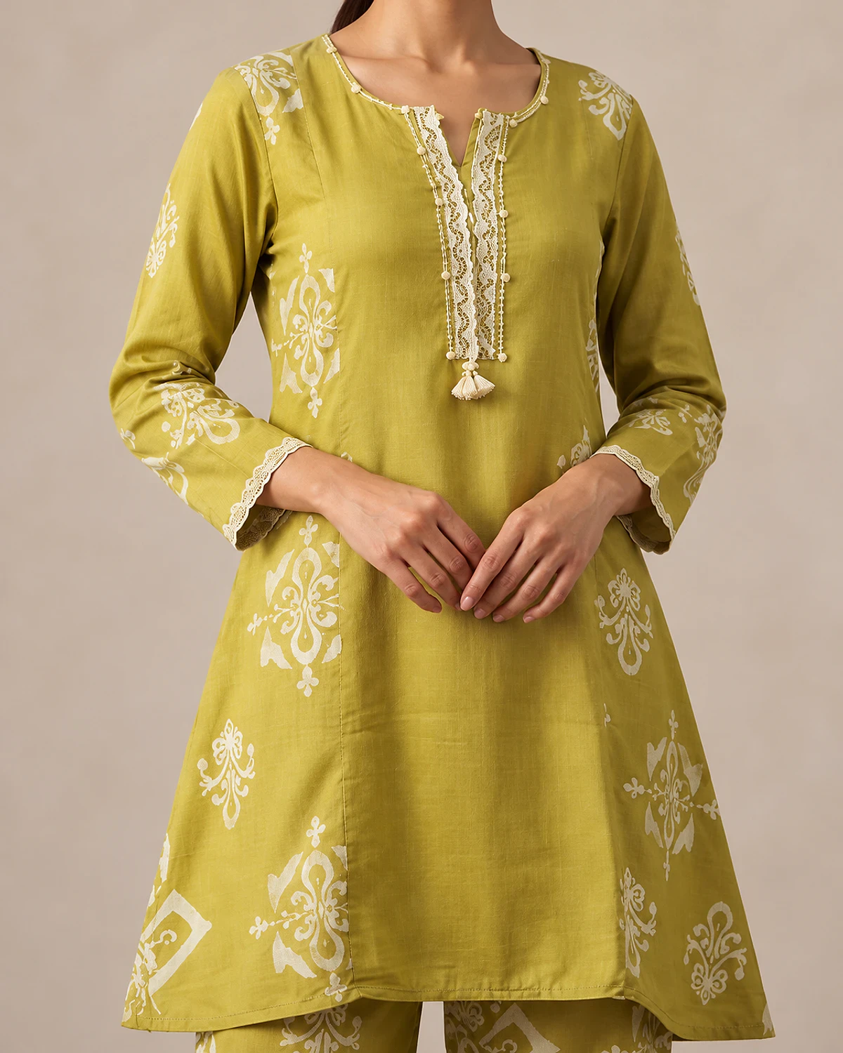 Close-up of the mehendi green kurta's lace placket and cuffs