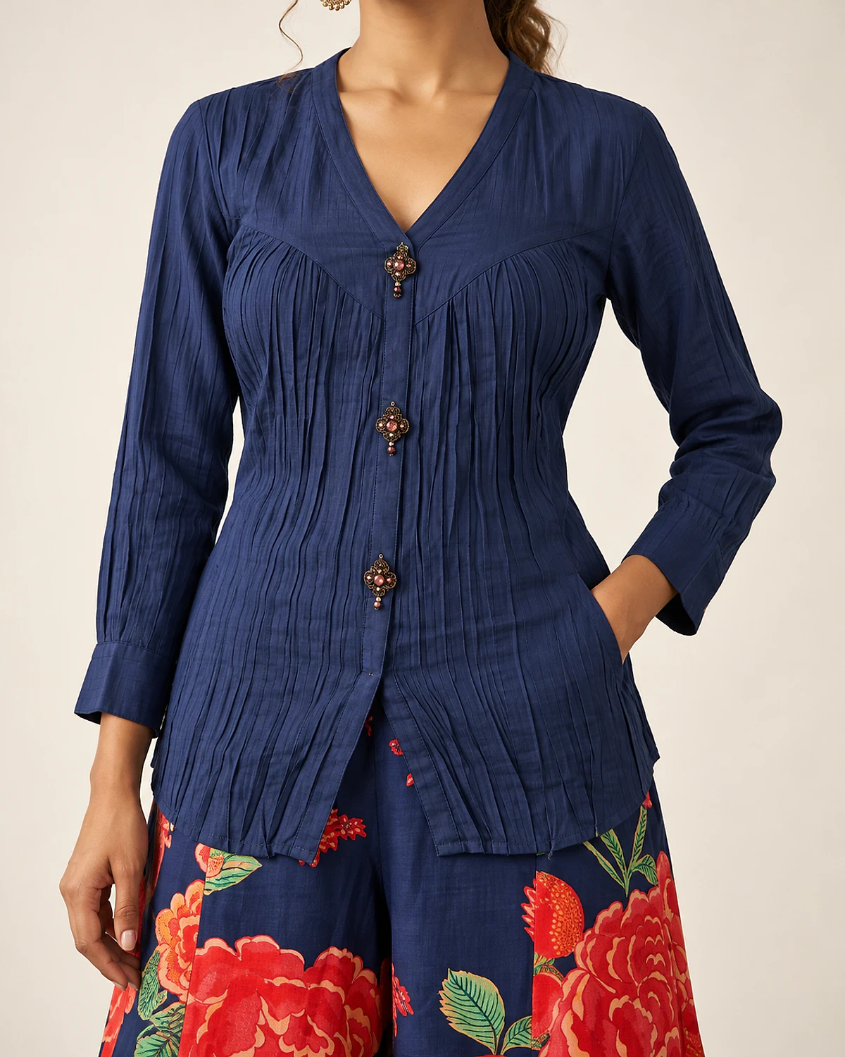 Close-up of the navy top's crinkle texture and ornate buttons