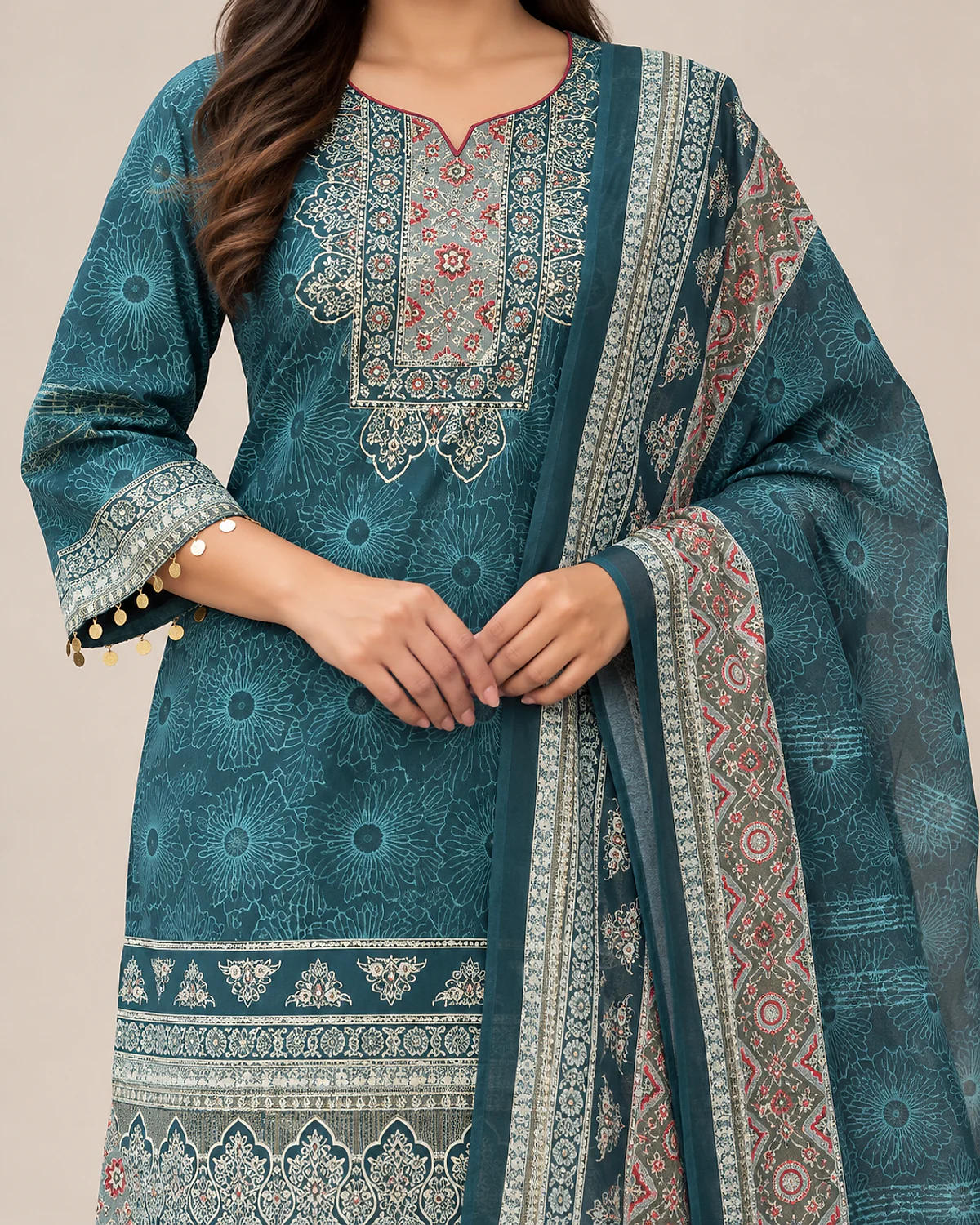 Close-up of the teal kurta's ornate yoke and printed borders