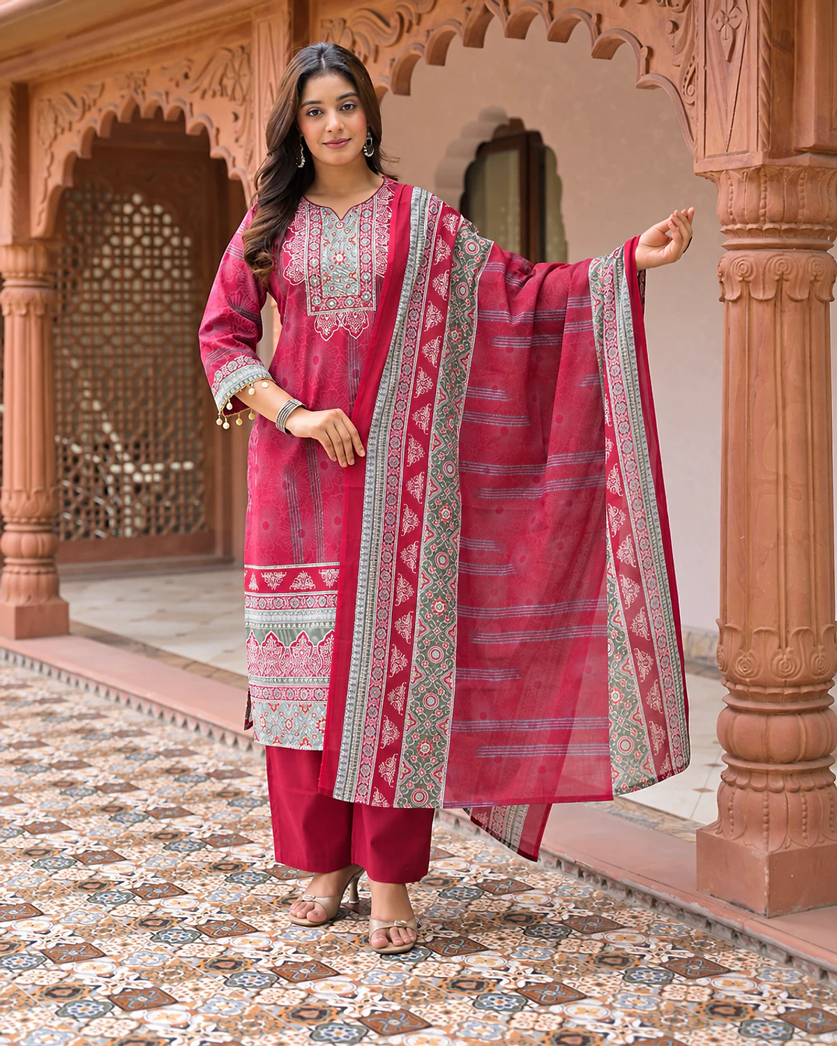 Woman wearing a magenta printed cotton kurta, trousers and dupatta