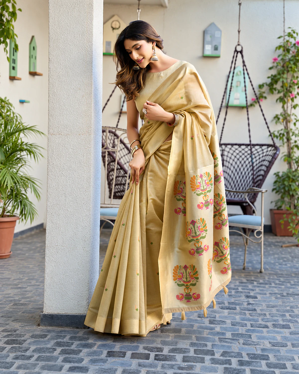 Woman in the champagne Surbhi cotton jacquard saree showing its Paithani-style pallu