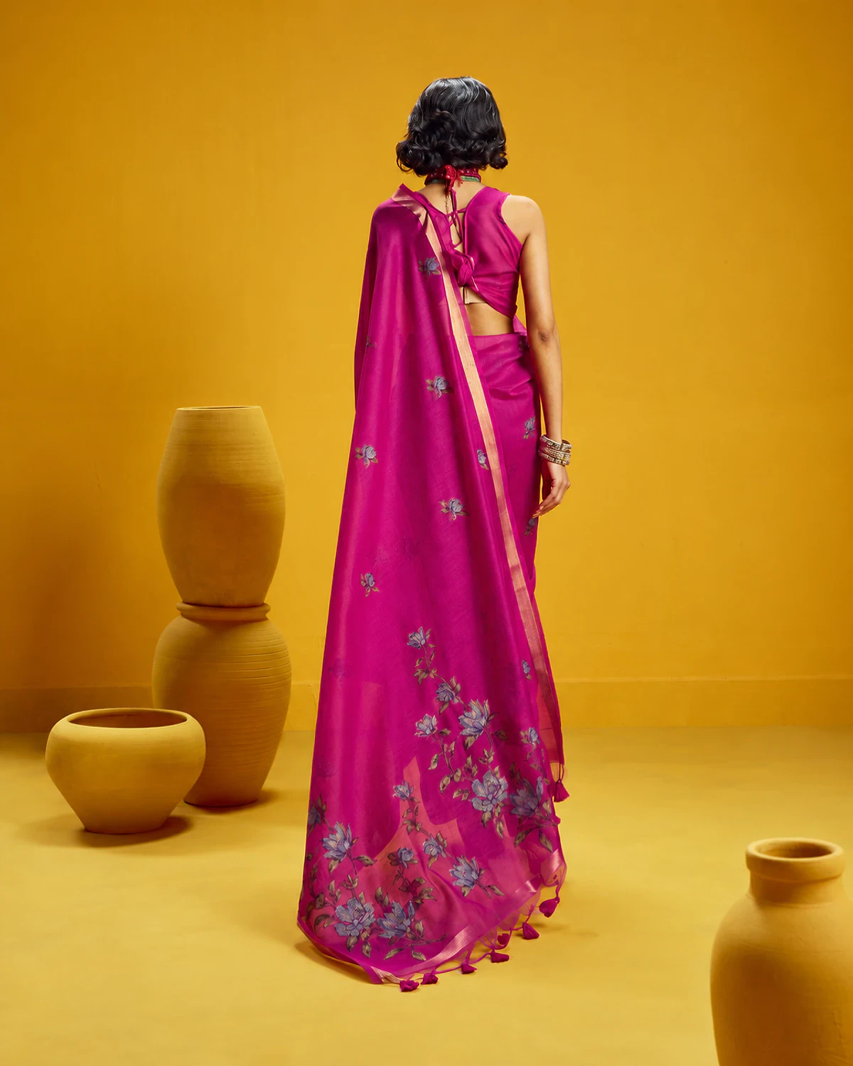 Back view of the magenta Noorani munga cotton saree, its flower-covered pallu falling down the back