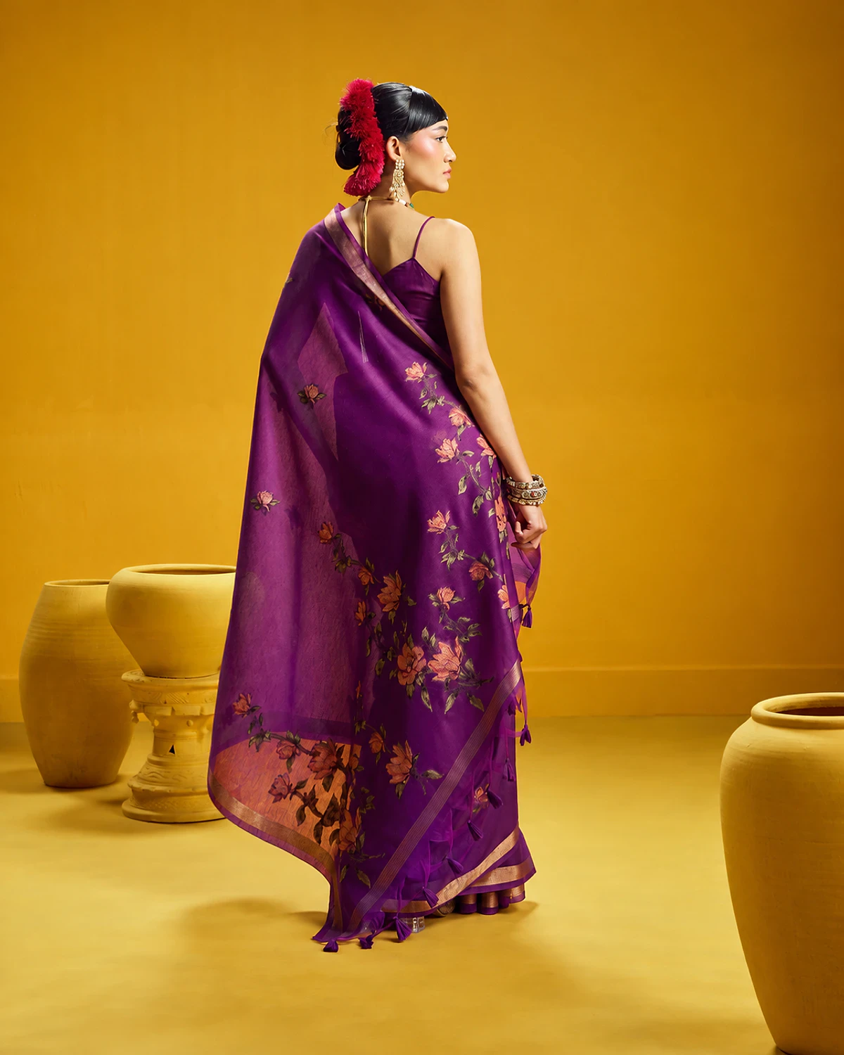 Back view of the purple Noorani munga cotton saree, its flower-covered pallu falling down the back