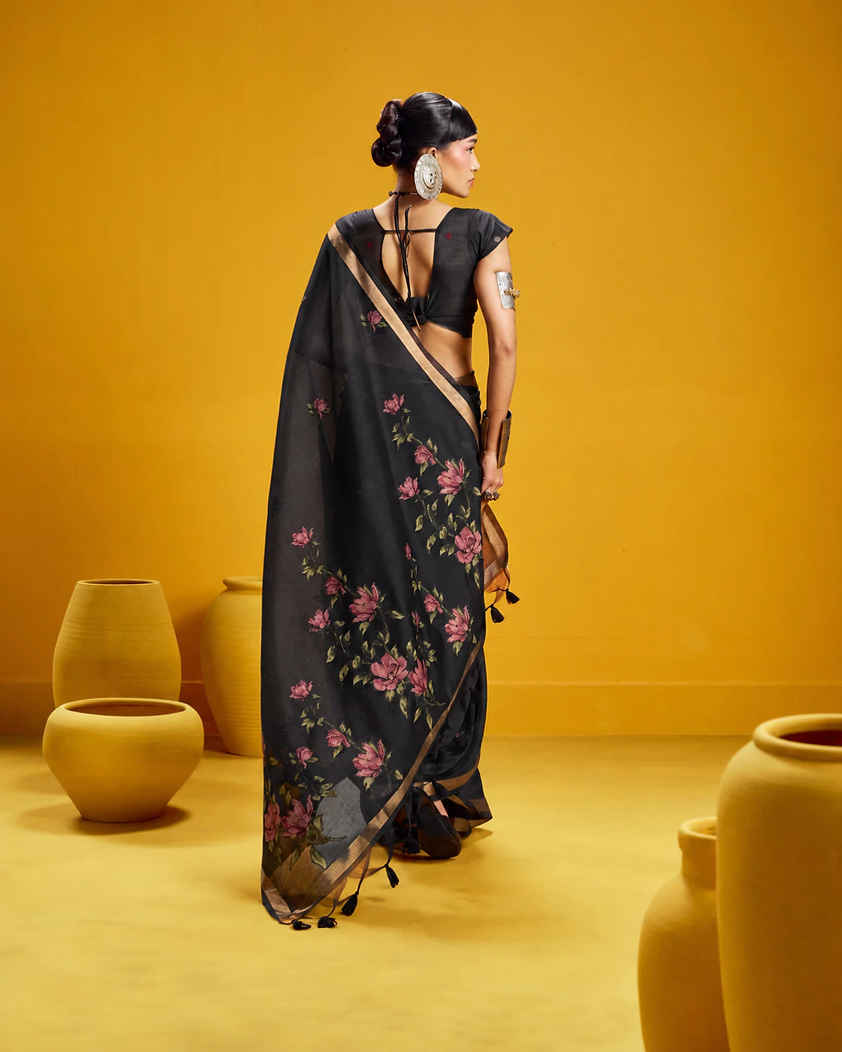 Back view of the black Noorani munga cotton saree, its flower-covered pallu falling down the back