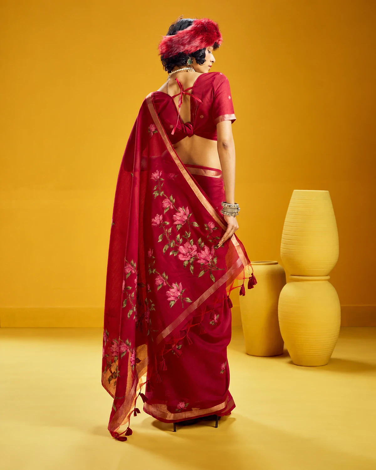 Back view of the crimson Noorani munga cotton saree, its flower-covered pallu falling down the back