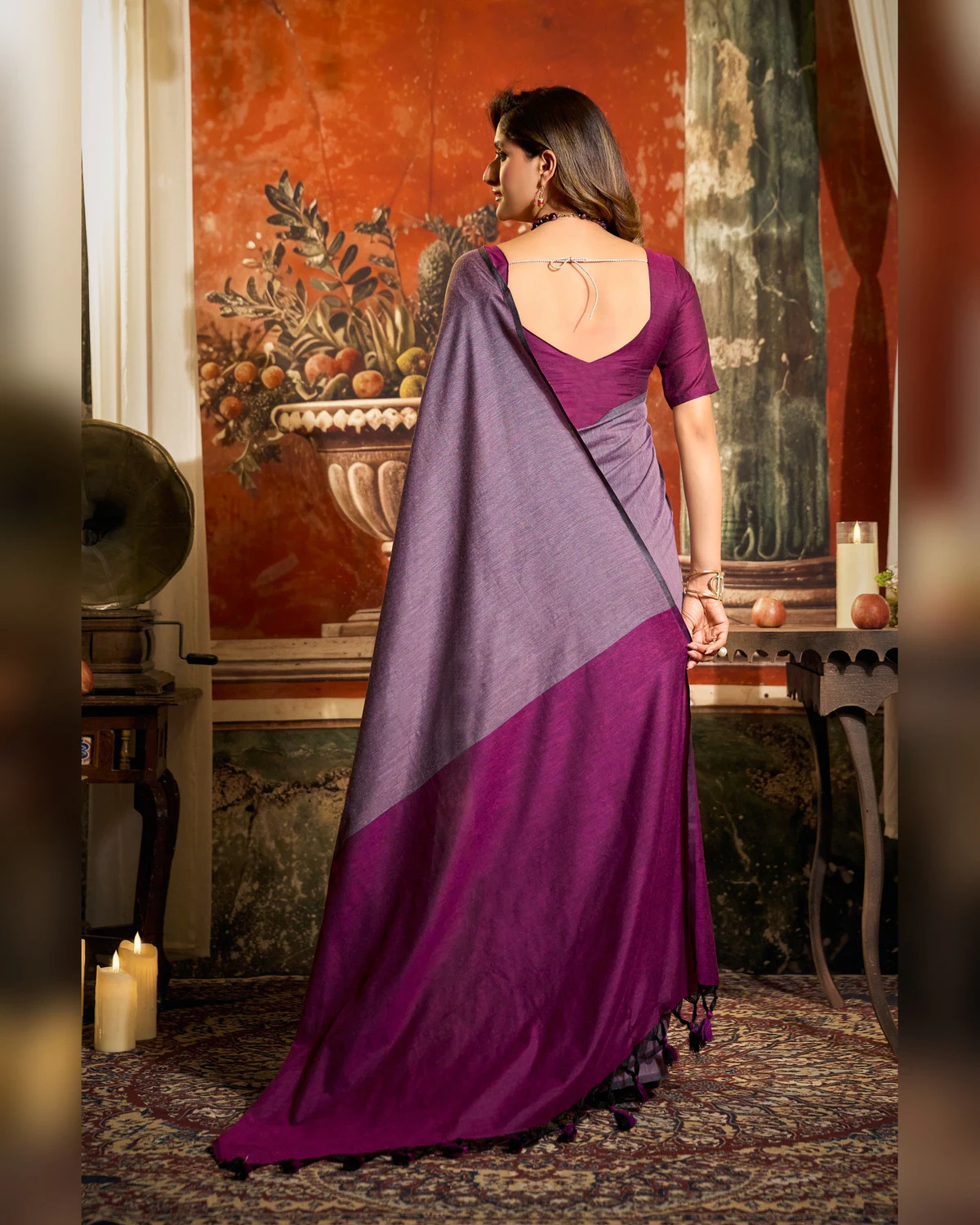 Back view of the lilac grey mal cotton saree, its purple pallu falling down the back over a purple blouse
