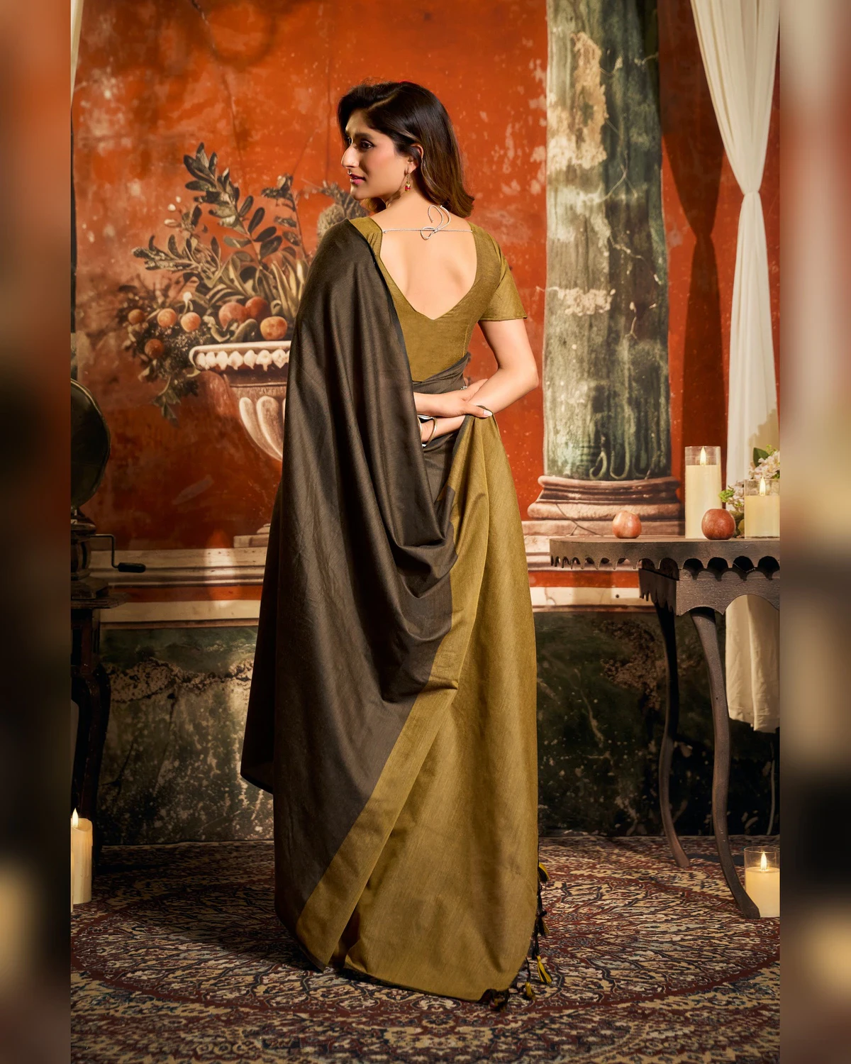 Back view of the dark brown mal cotton saree with its olive pallu and olive blouse
