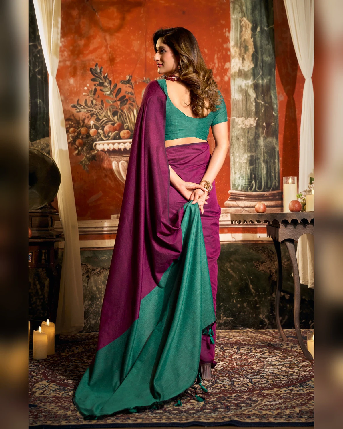 Back view of the magenta mal cotton saree, holding its teal-green pallu