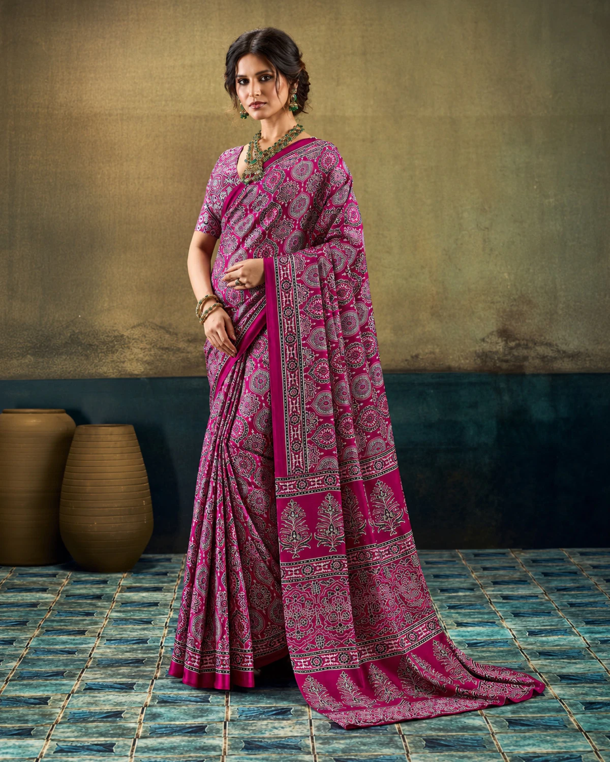 Woman in the plum modal satin saree with its long Ajrakh print pallu falling to the floor