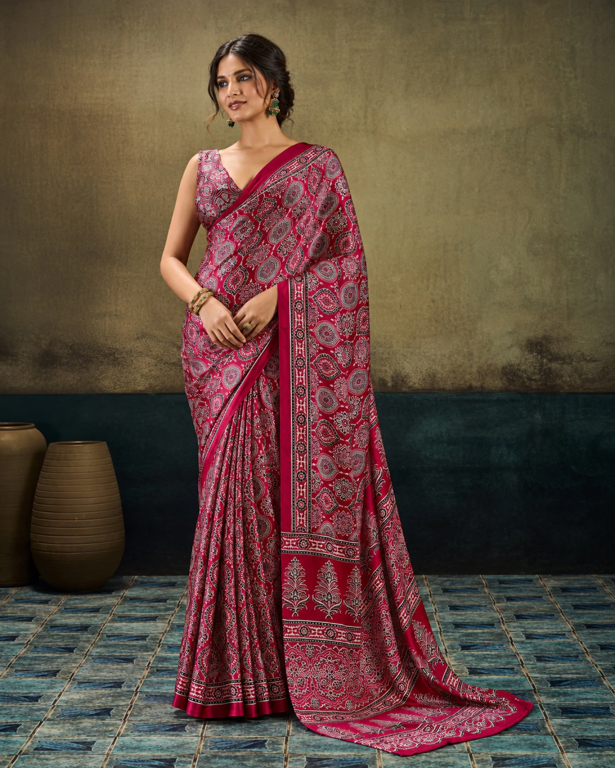 Woman in the crimson modal satin saree with its long Ajrakh print pallu falling to the floor