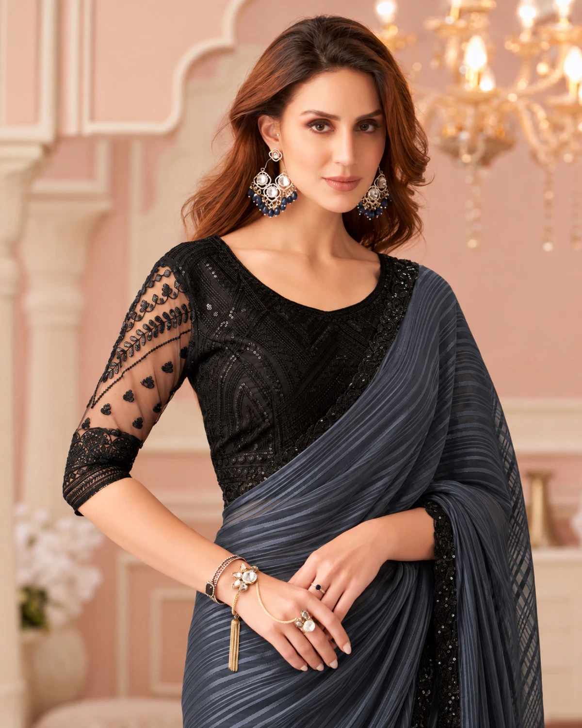Close-up of the charcoal grey georgette saree's wavy stripes with a black embroidered blouse