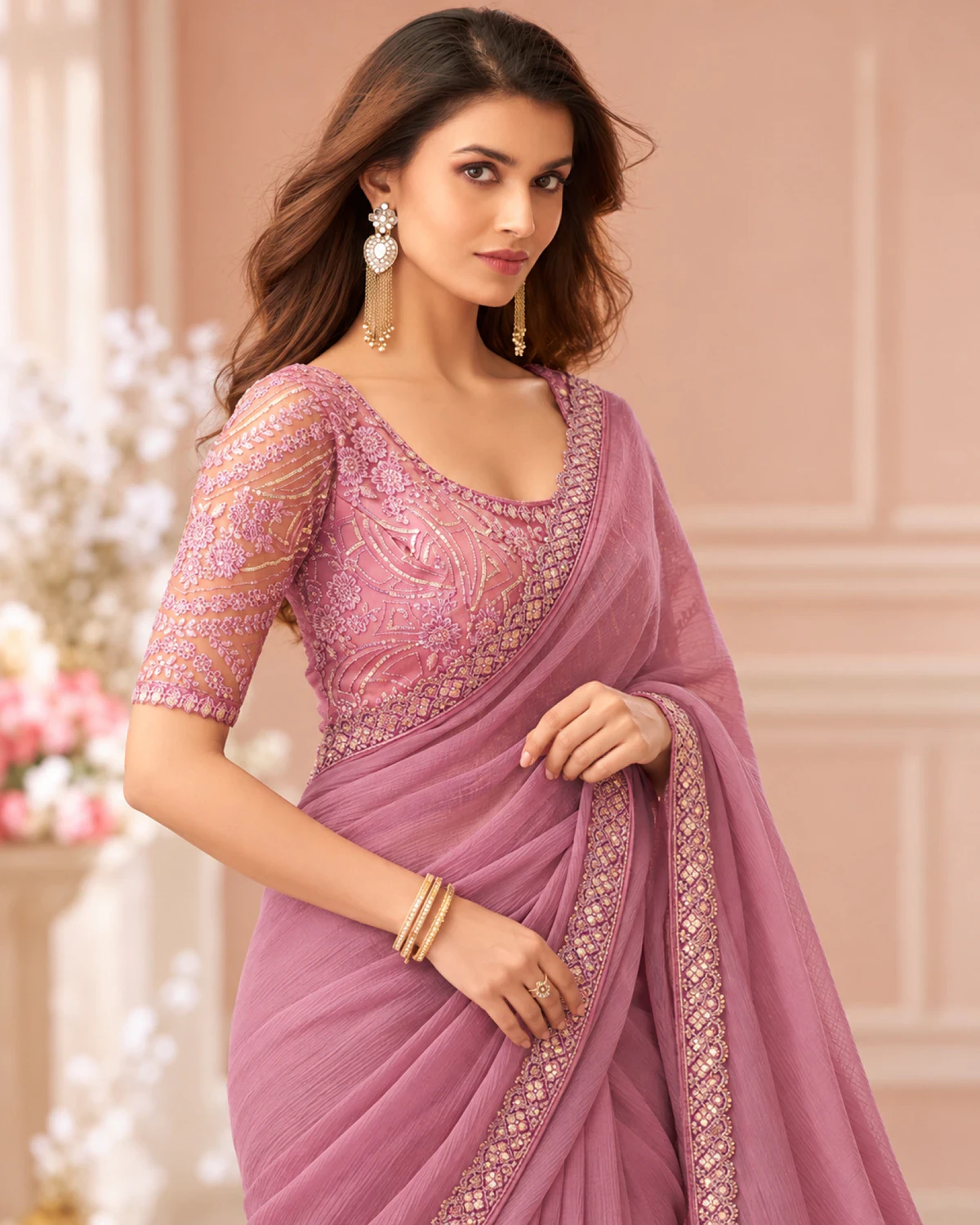 Close-up of the dusty pink georgette saree's border with a matching embroidered blouse