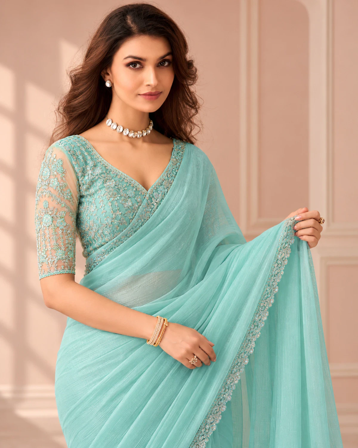 Close-up of the aqua blue georgette saree's border with an aqua embroidered blouse