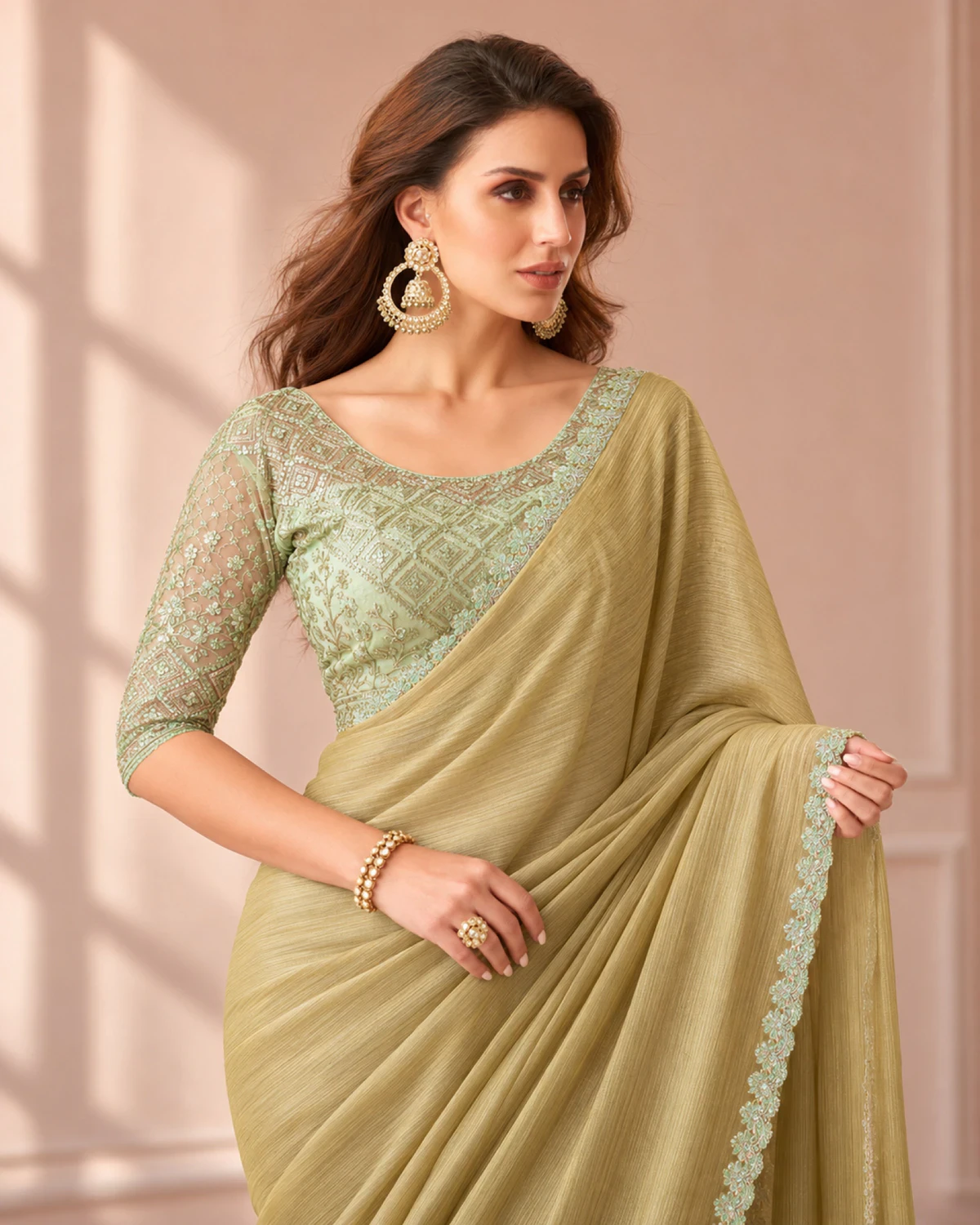 Close-up of the olive beige georgette saree's mint border with a mint green embroidered blouse