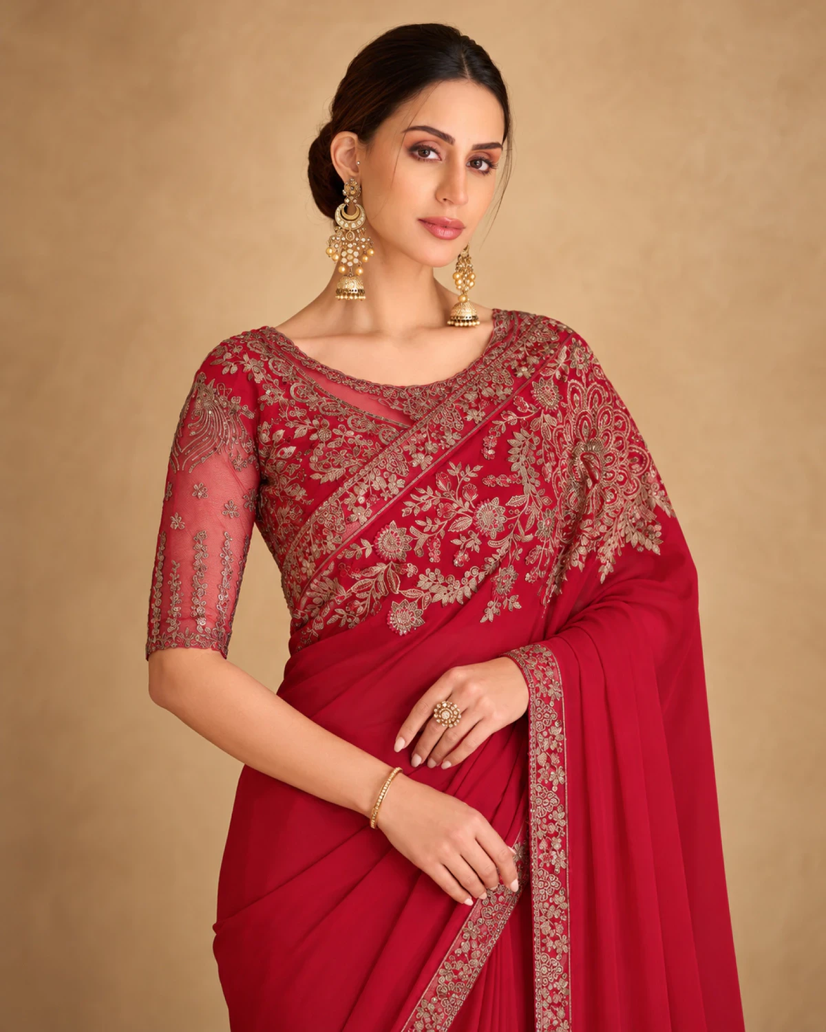 Close-up of the red sparkle georgette saree's embroidered shoulder and the red embroidered blouse