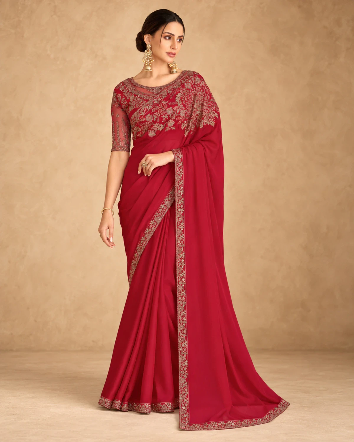 Full-length view of the red sparkle georgette saree with its gold embroidered border