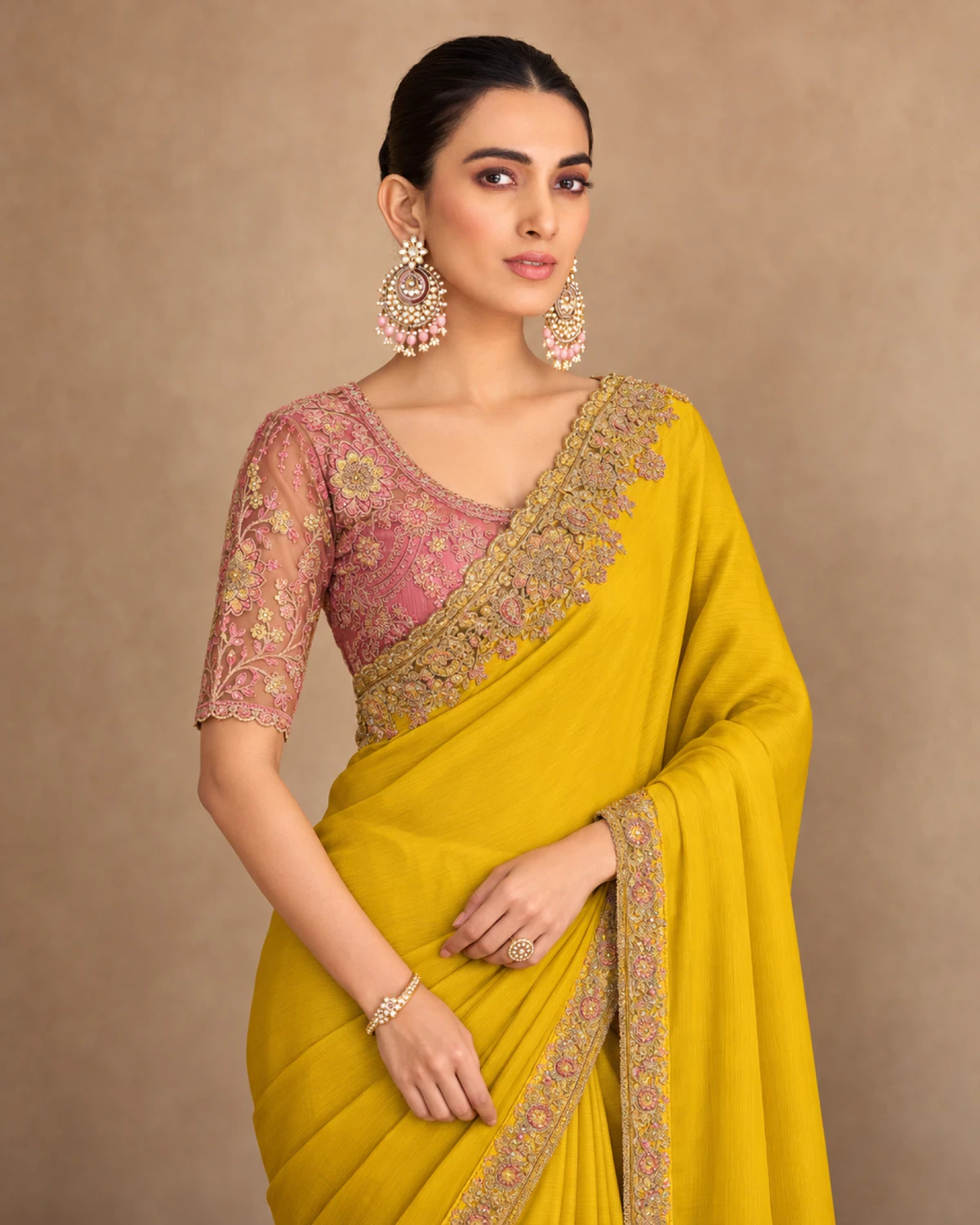Close-up of the yellow satin chiffon saree's embroidered shoulder and the dusty rose embroidered blouse